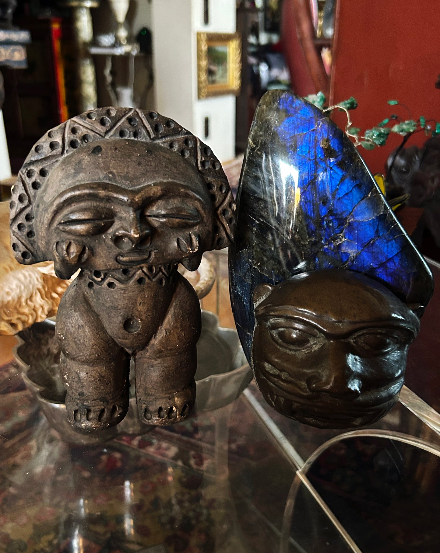 Taino-style stone figure displayed in context with decorative props