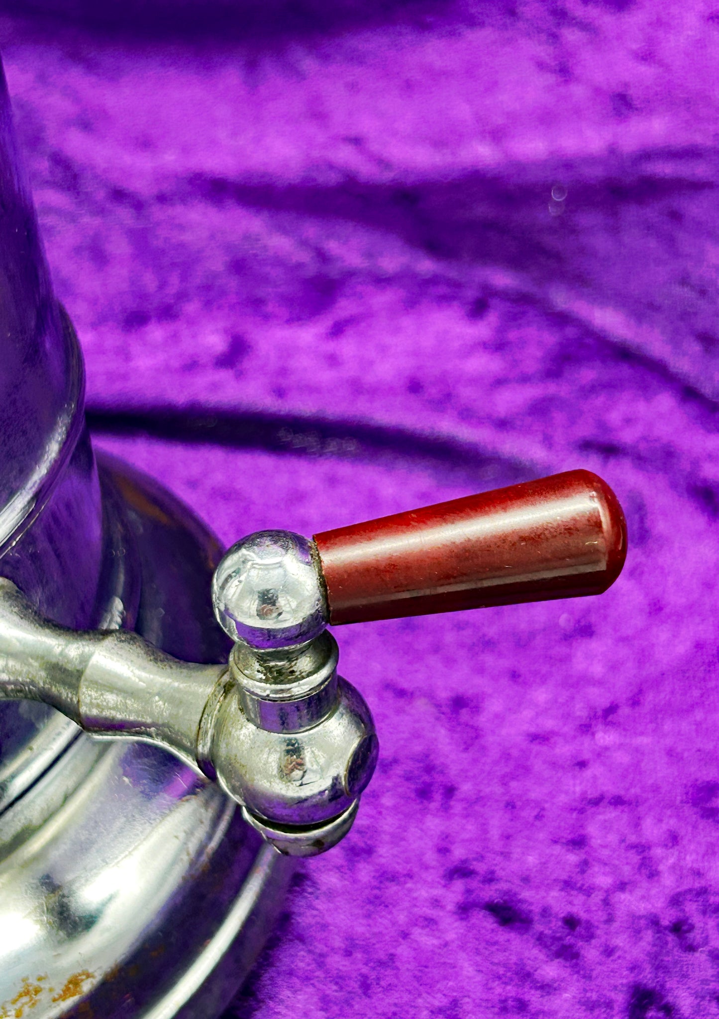 Marbled bakelite tap handle on vintage DDR coffee percolator, close-up