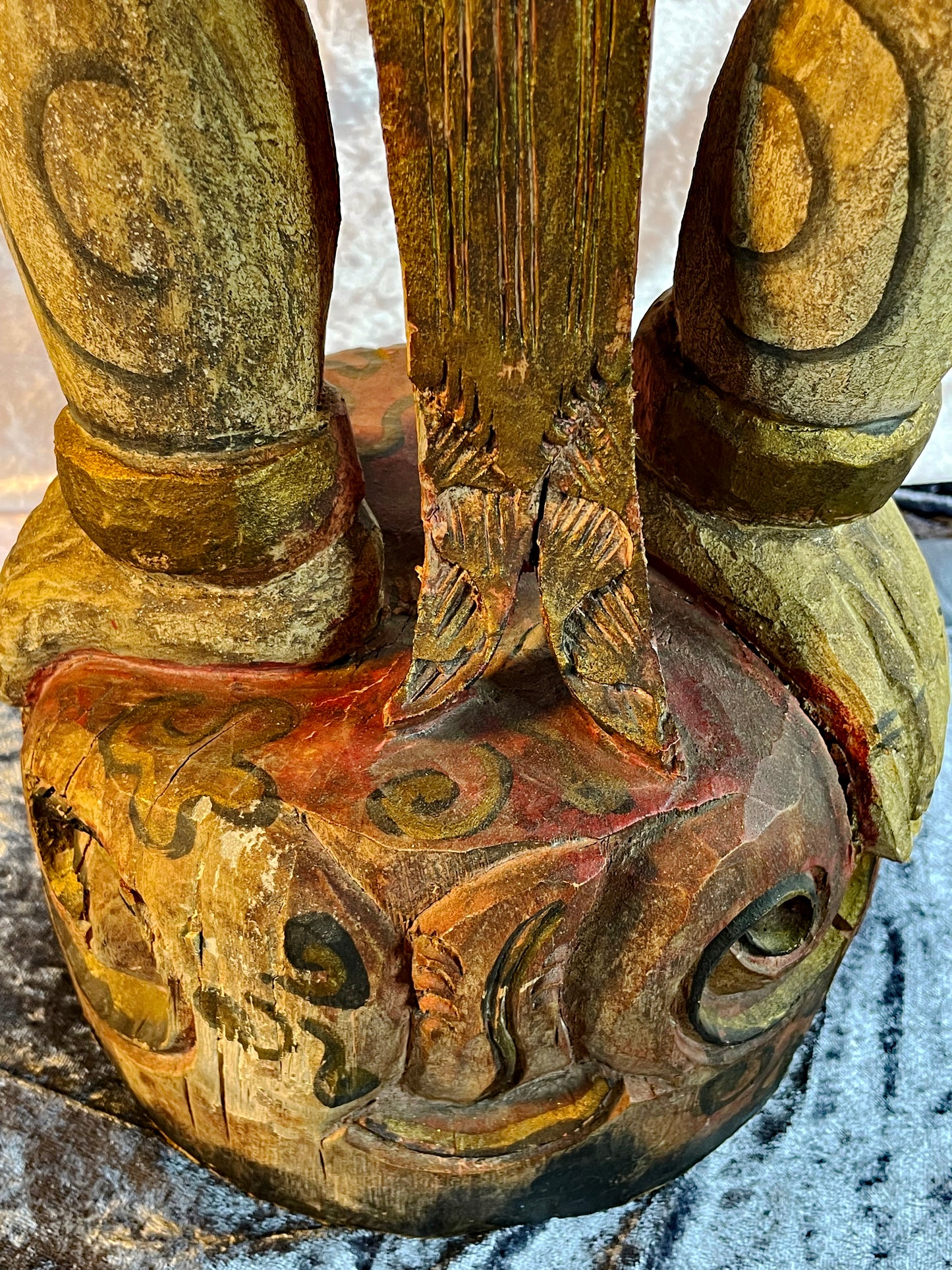 Detail view of the hand-carved ornament and patina