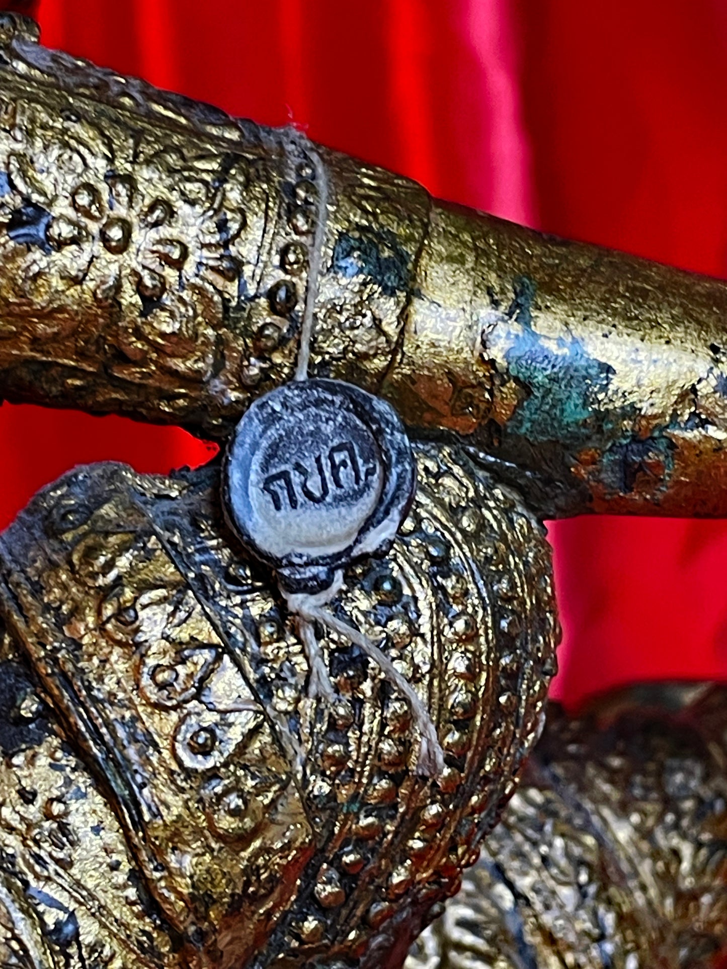 Detail of the wax provenance seal with Thai script on the bronze