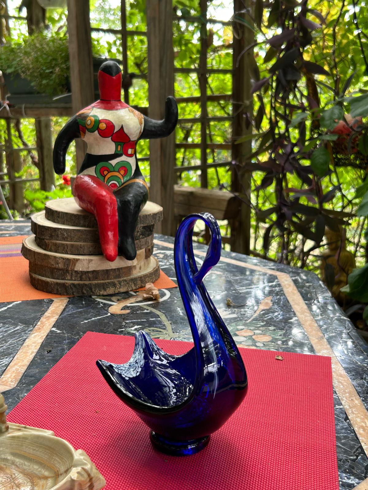 Cobalt blue Murano glass swan figurine shown in full with decorative setting
