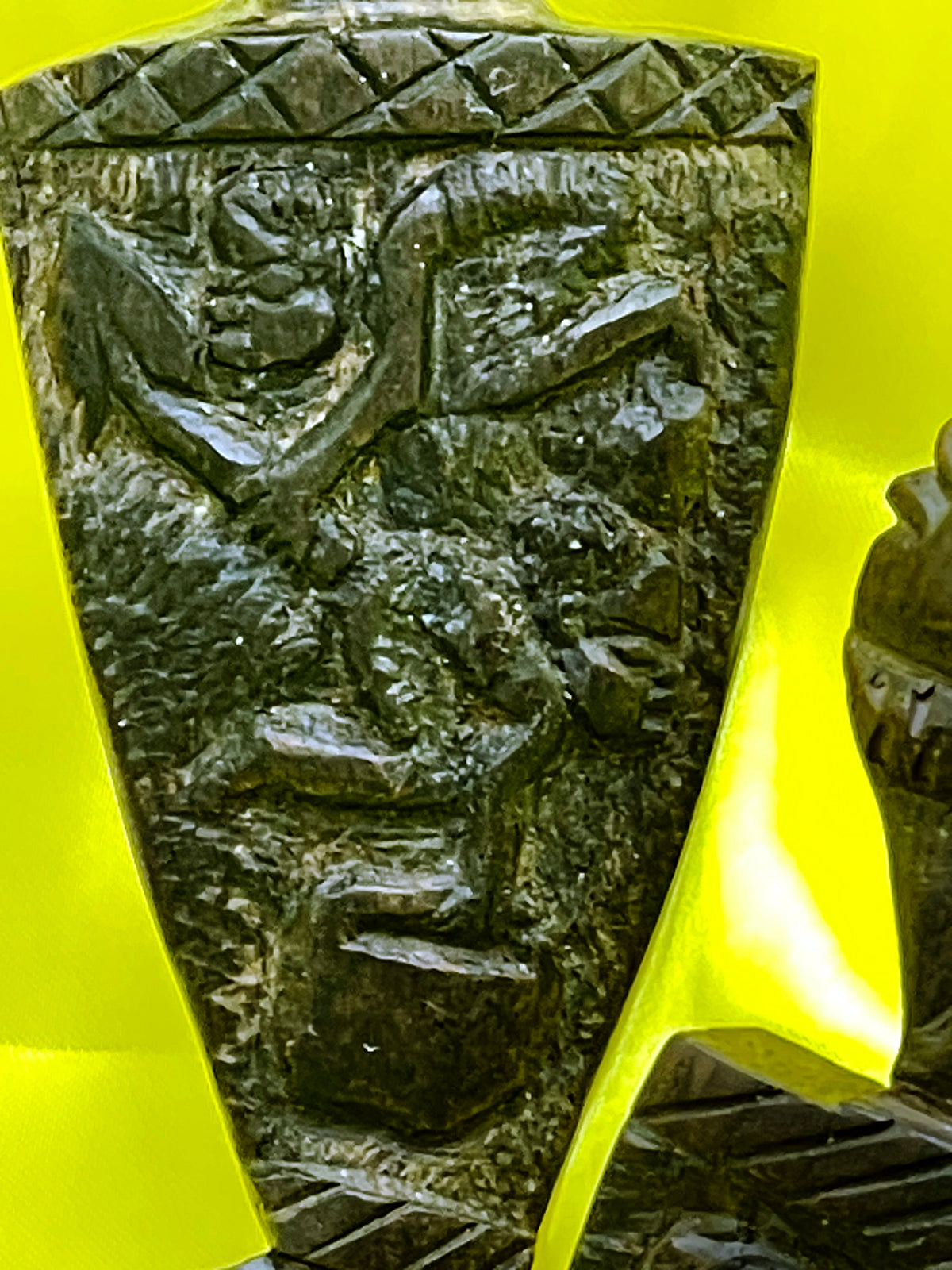 Detail of the relief carving with scenes of daily life on the handle