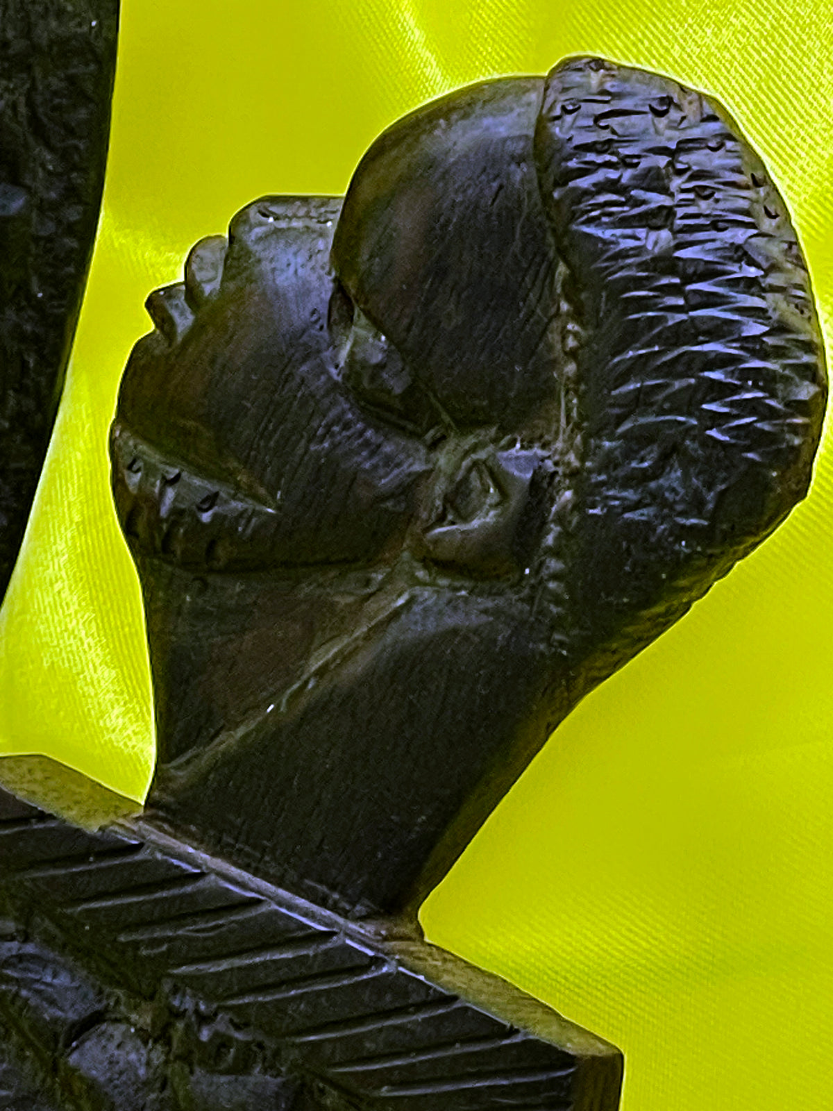 Detail of the carved busts and crosshatched border decoration