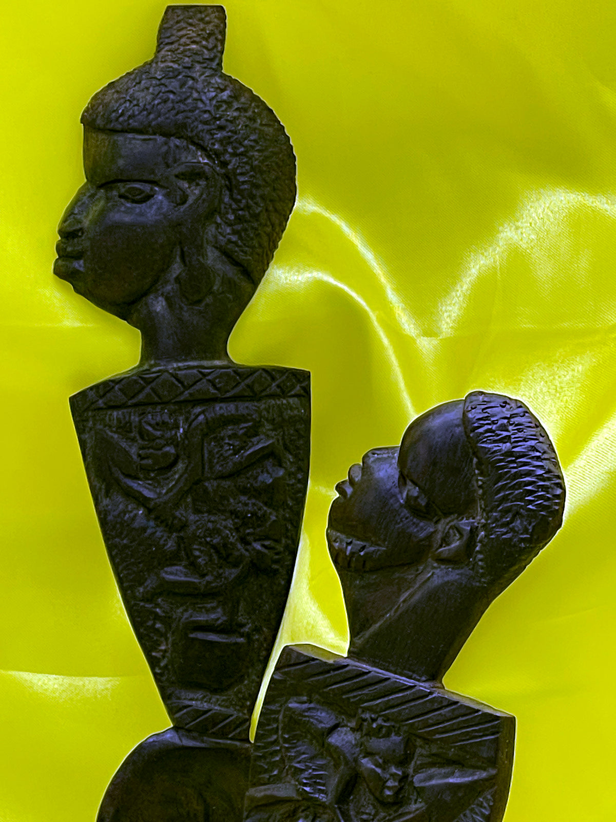 Hand carved African ebony spoon and fork pair with woman and man busts, hero view