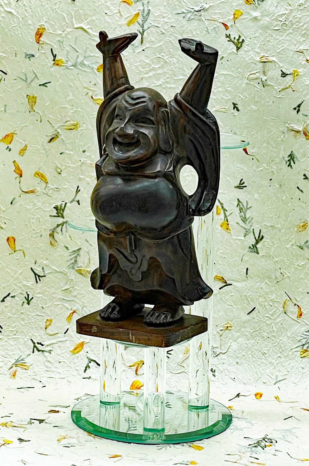 Detail of the hand carved face and joyful expression of the ebony Happy Buddha