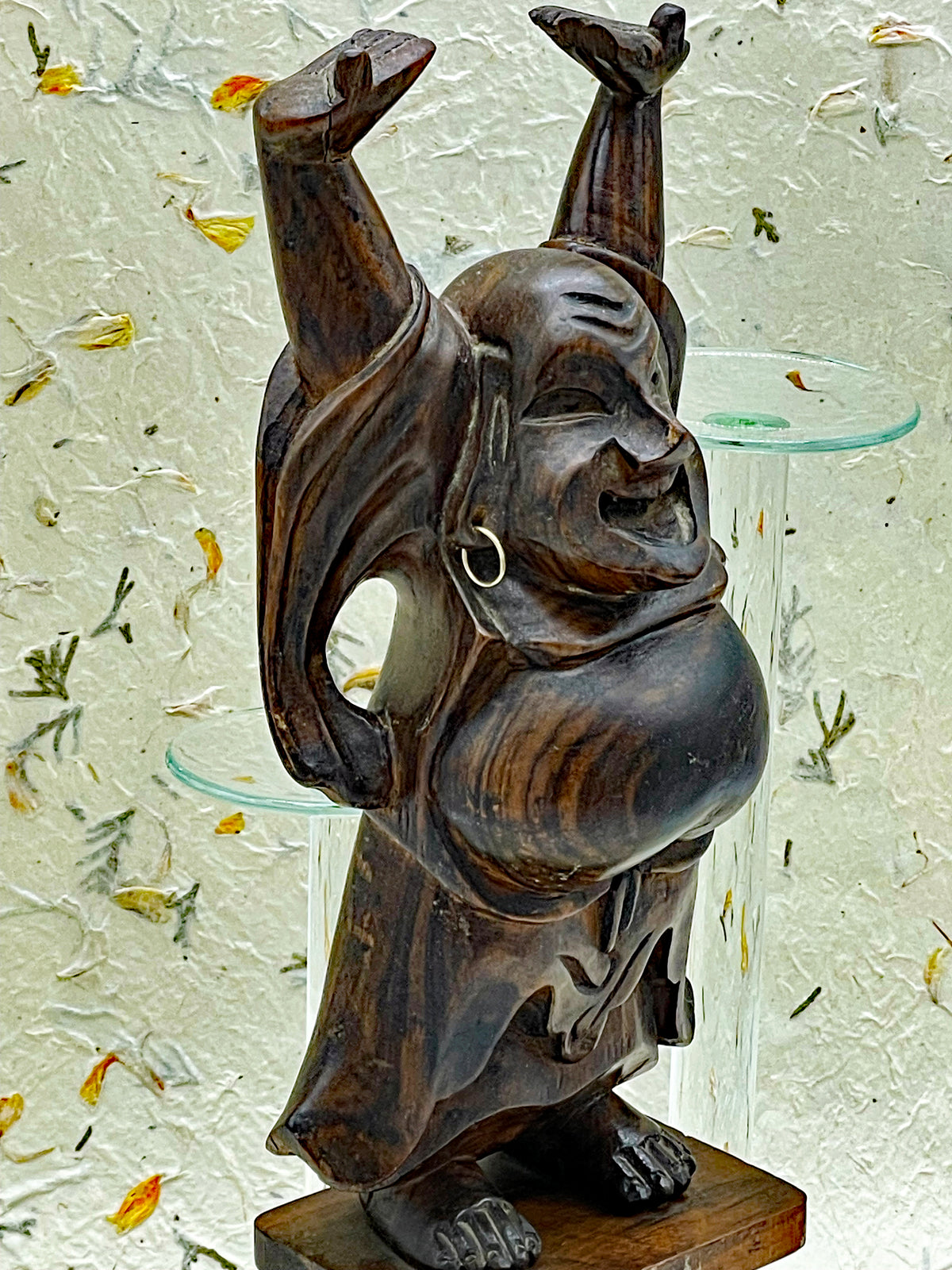 Detail of the ebony grain and carved robe of the Happy Buddha statue