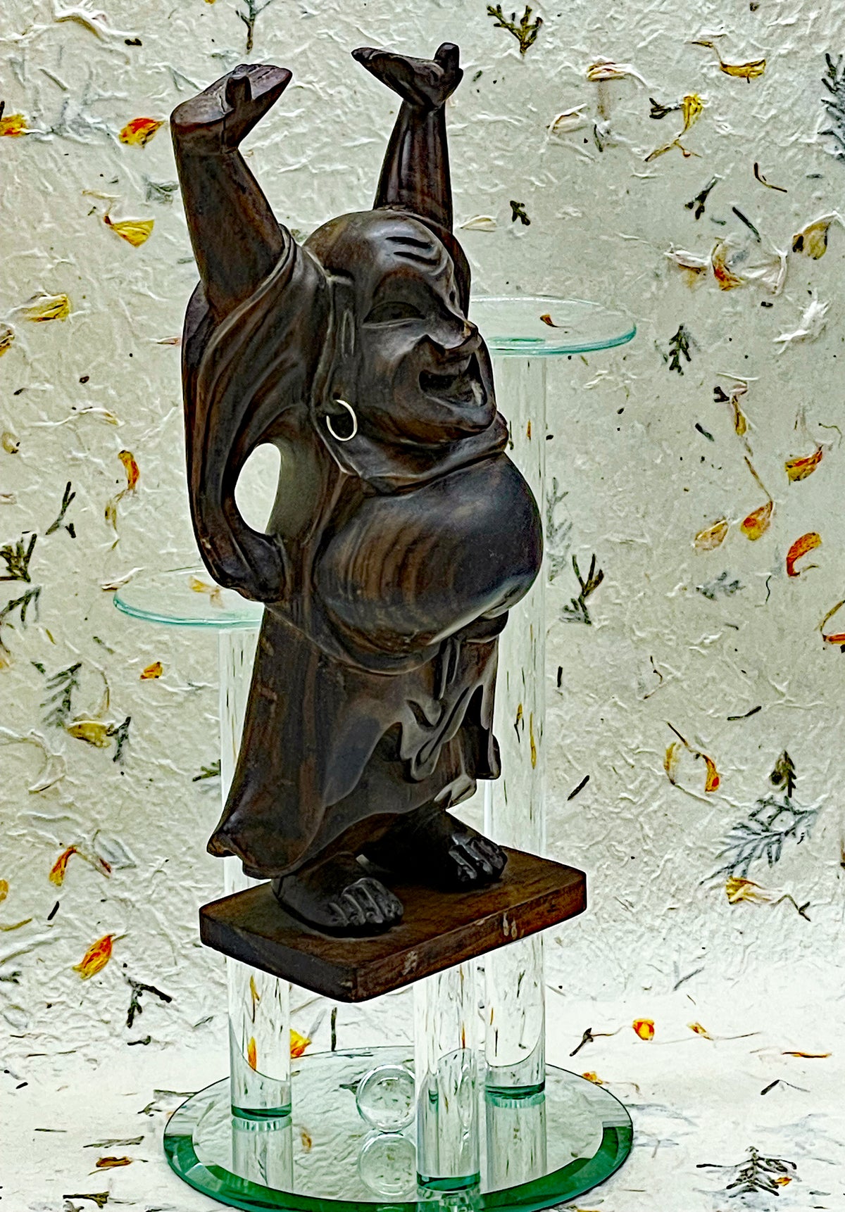 Detail of the carved belly and robe of the vintage ebony laughing Buddha