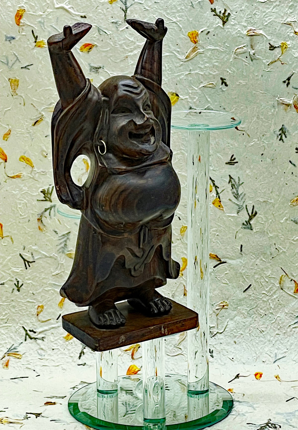 Back view of the ebony Happy Buddha showing carved sack and striped wood grain