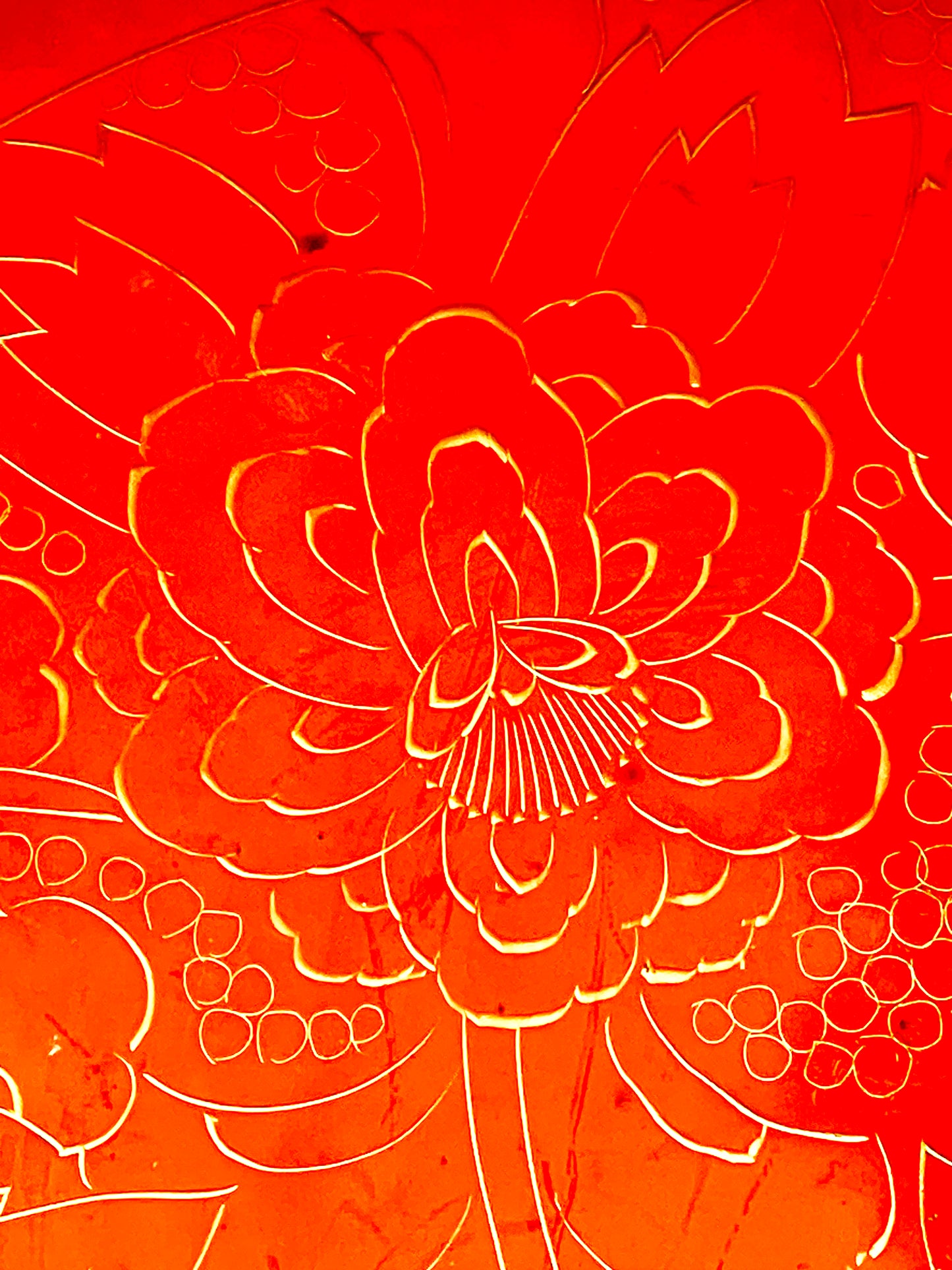 Close-up of an engraved gold peony bloom with fine stamen crown