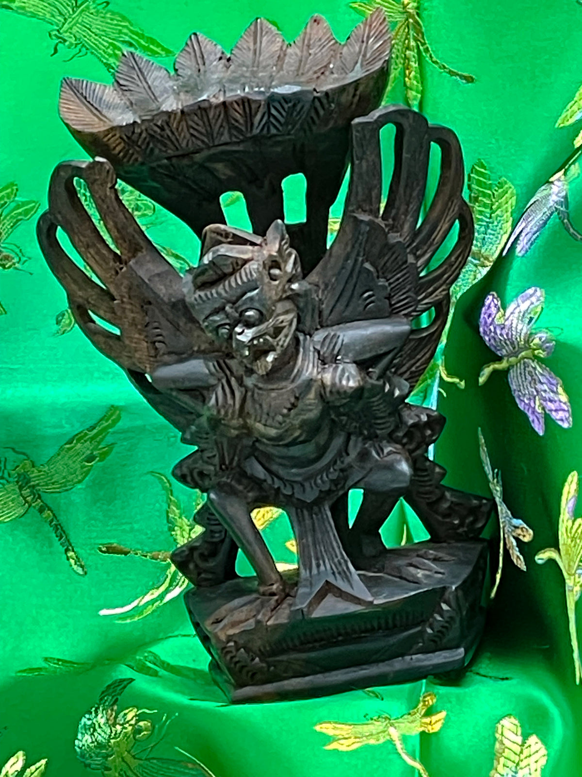 Angled view of the ebony Garuda statue with fanned tail feathers