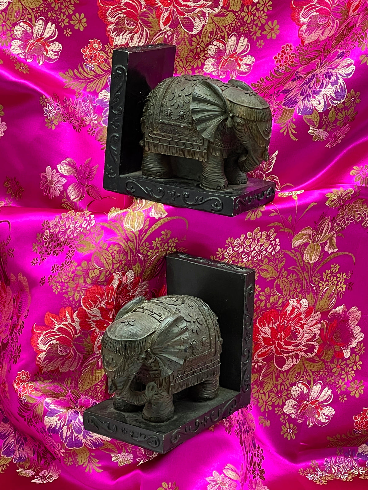 Both elephant bookends angled view showing fringed caparisons and scrolled plinths