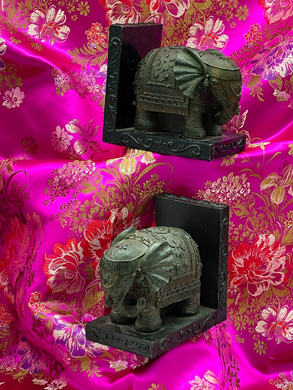 Pair of elephant bookends facing opposite directions with L shaped backplates