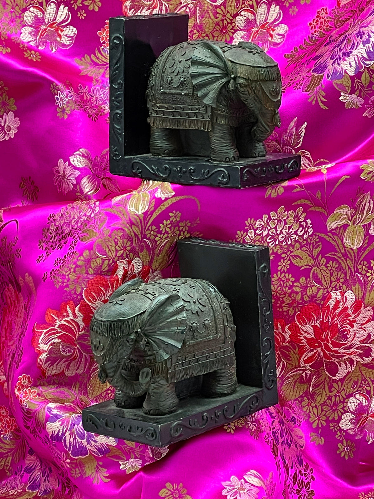 Antique elephant bookends pair, side view showing ornate saddle blankets