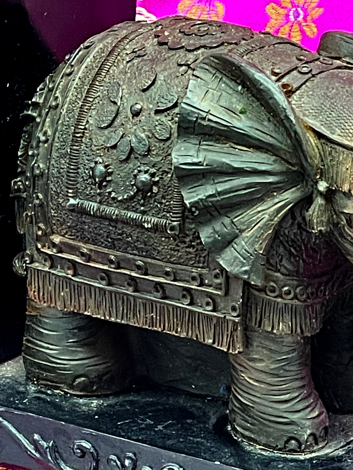 Close up of caparison with floral relief, studs and fringe over the hind legs