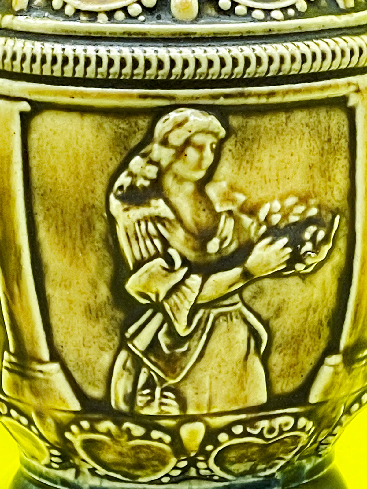 Close up of dancer with garland relief on vintage German Henkelkrug