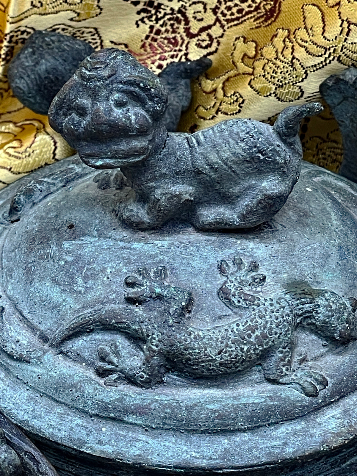 Detail of the cast bronze decorations and green patina on the ritual teapot