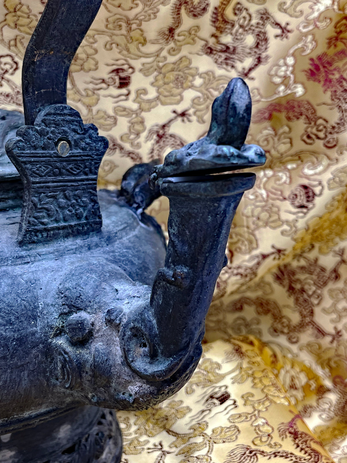 Detail of the elephant head spout with curled trunk and cast bronze guard plaque