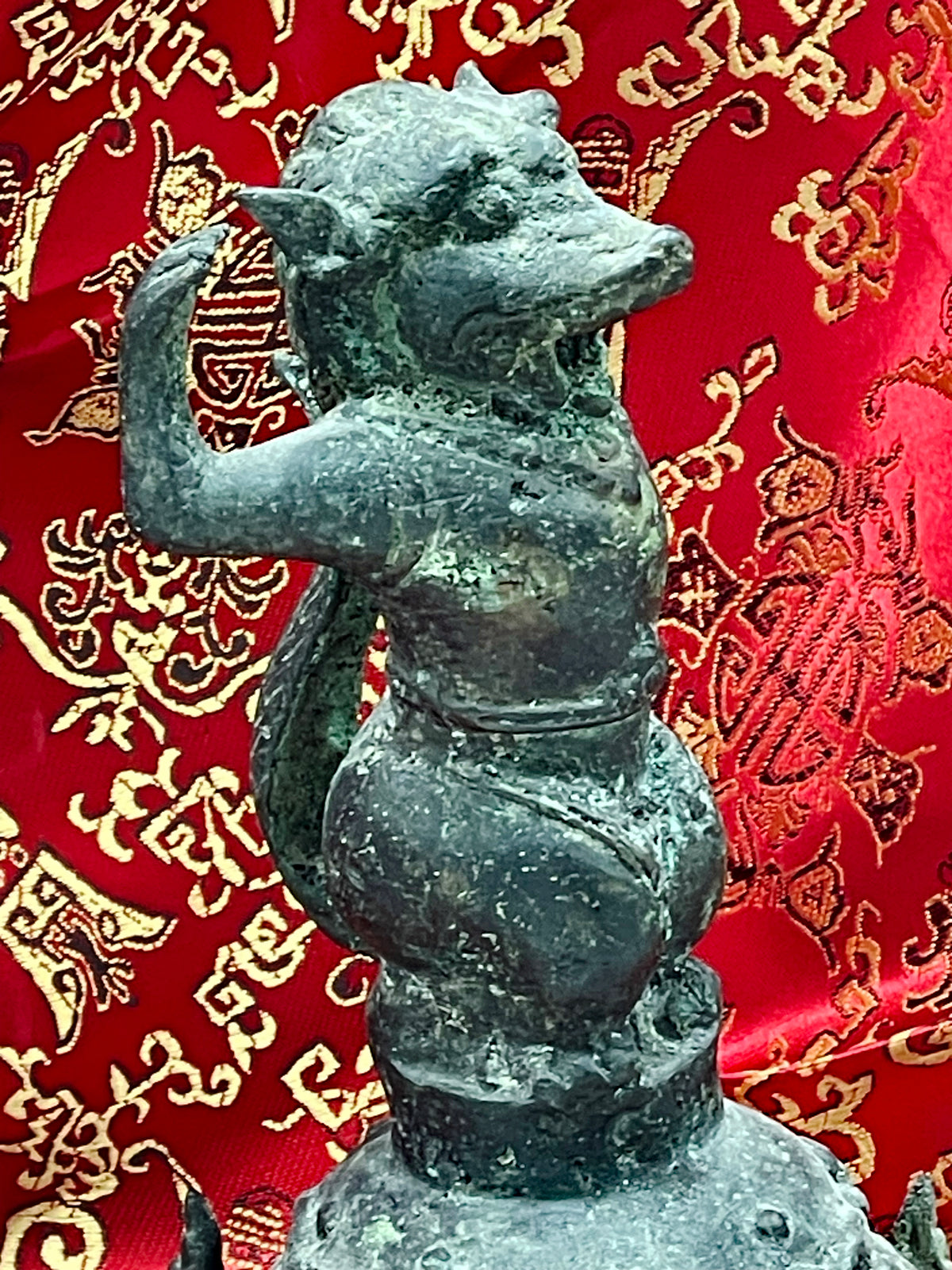 Profile detail of the mythical monkey guardian on the Chinese bronze temple bell
