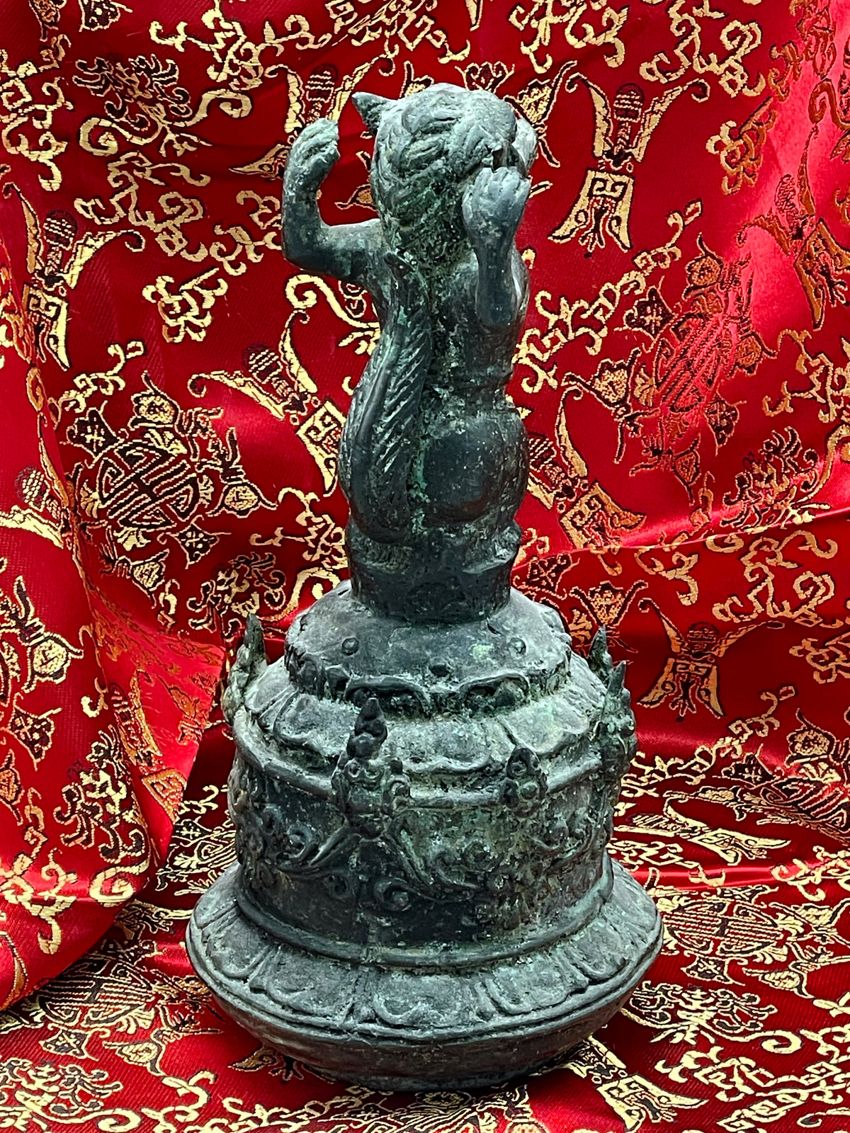 Rear view of the antique Chinese bronze ritual bell with flame studs and lotus base