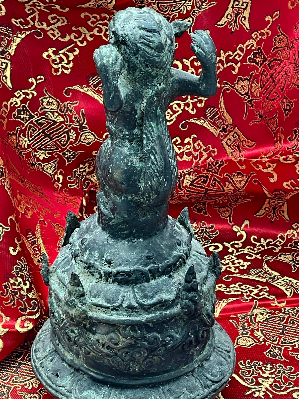 Three quarter rear view showing the ornate dome reliefs of the Chinese ritual bronze bell