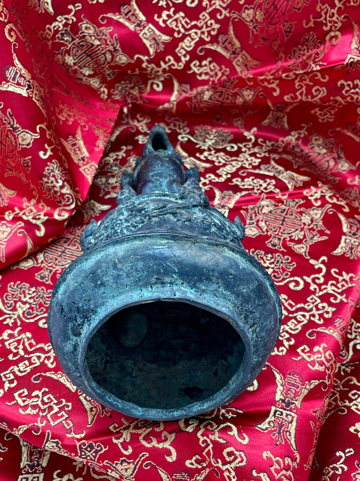 Underside of the antique Chinese bronze bell showing the hollow cast bell chamber
