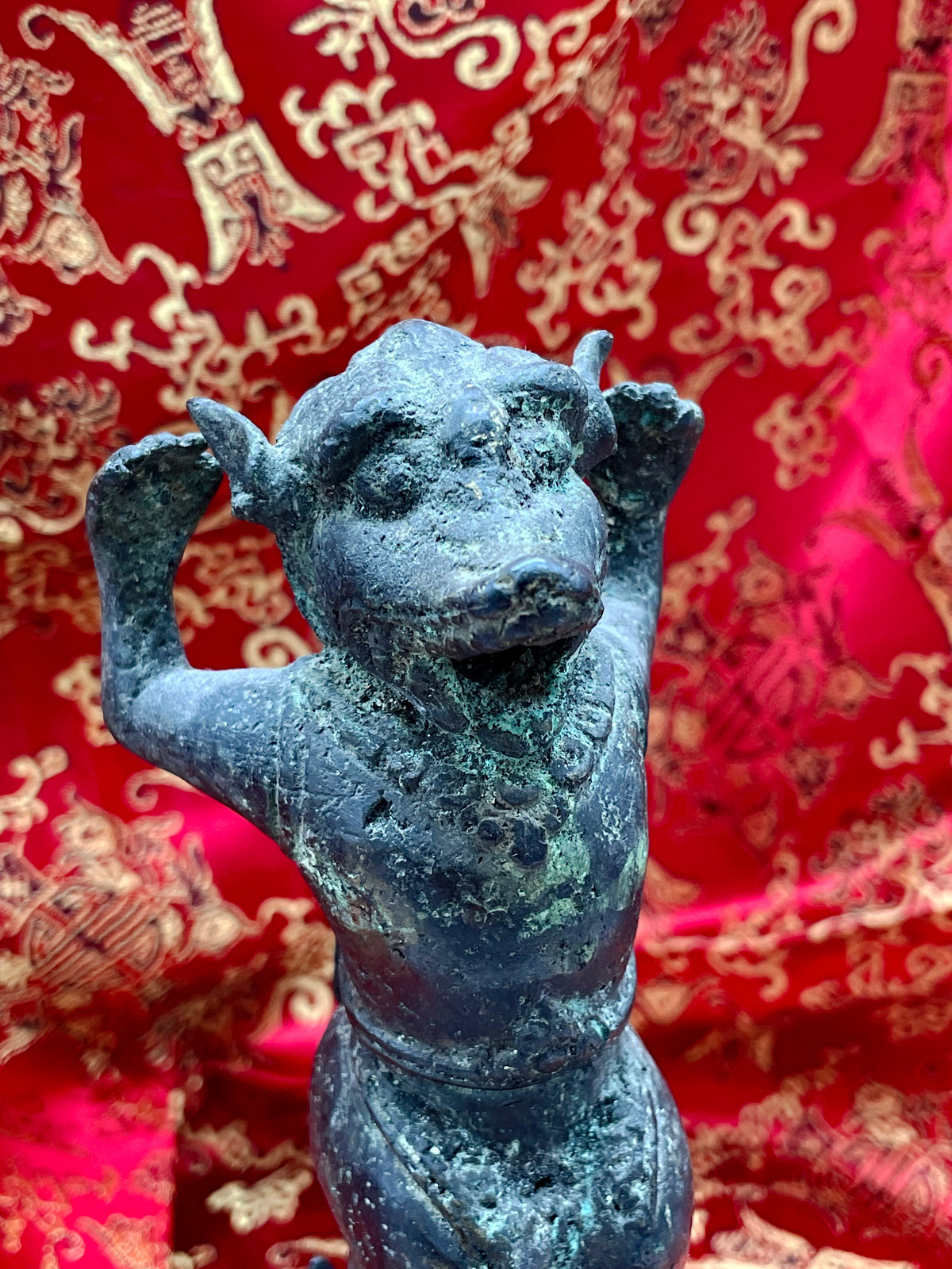 Detail of the guardian figure's face and beaded necklace, antique Chinese ritual bronze