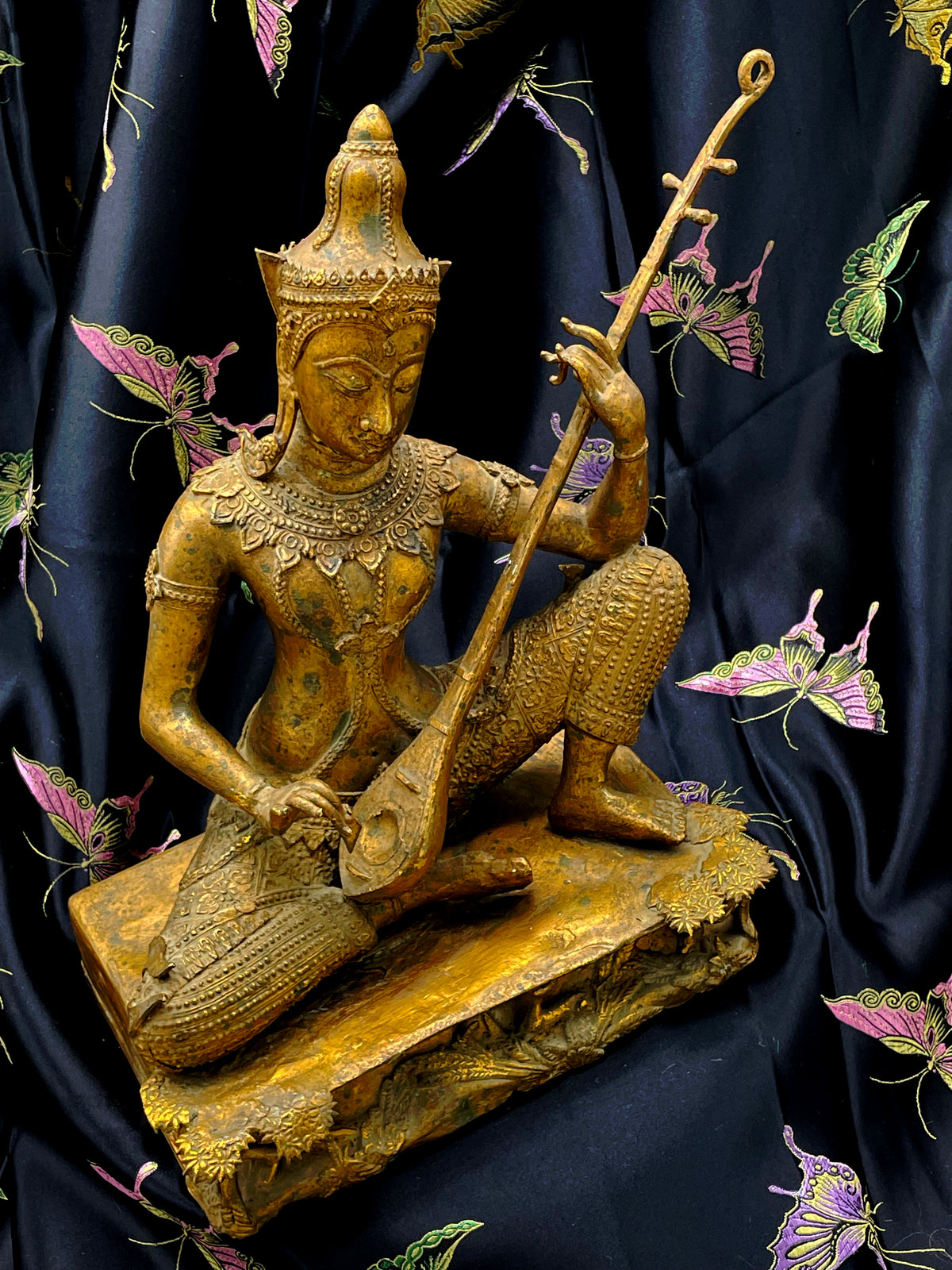 Antique Thai gilded bronze statue of Saraswati playing a vina, Rattanakosin style, front view on black silk