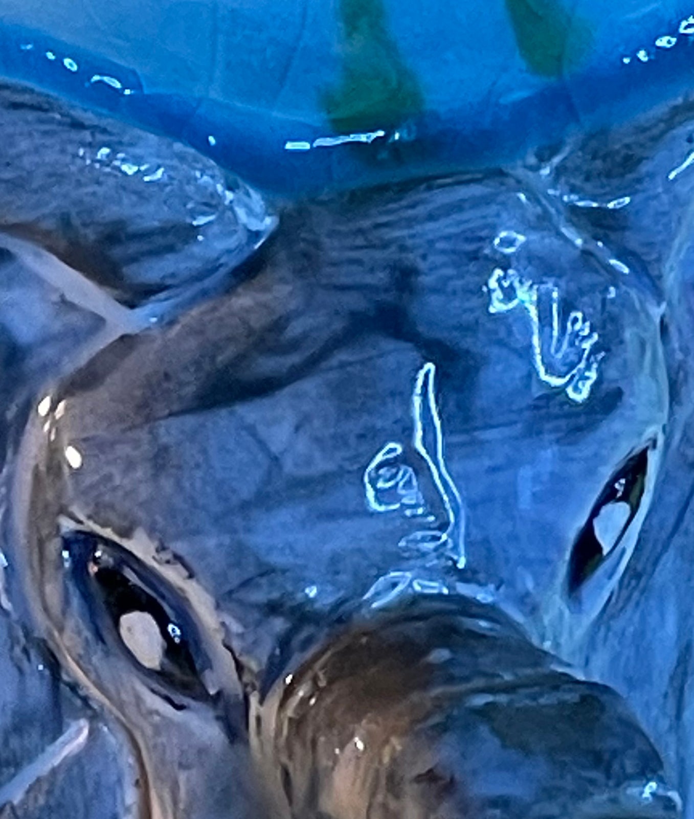 Hand-incised underglaze artist signature marks on the elephant relief