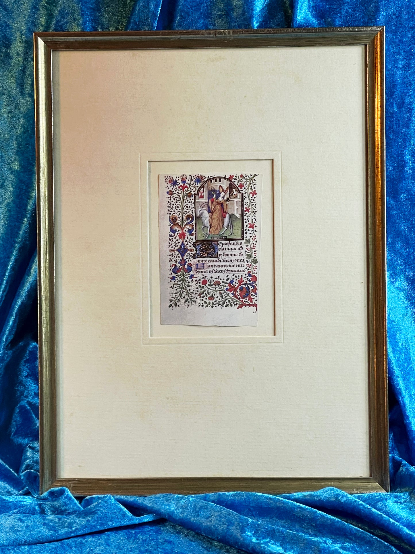 Framed illuminated Book of Hours miniature with saint under a gilded arch, silvered frame on blue velvet
