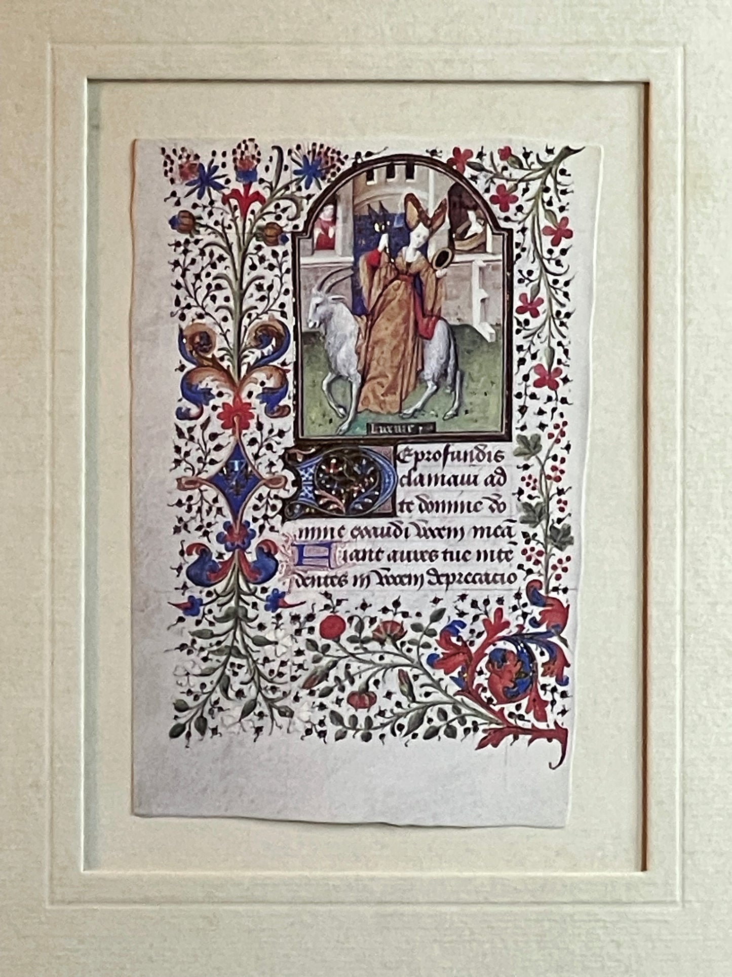 Illuminated manuscript leaf with a biblical procession scene and flowering acanthus border