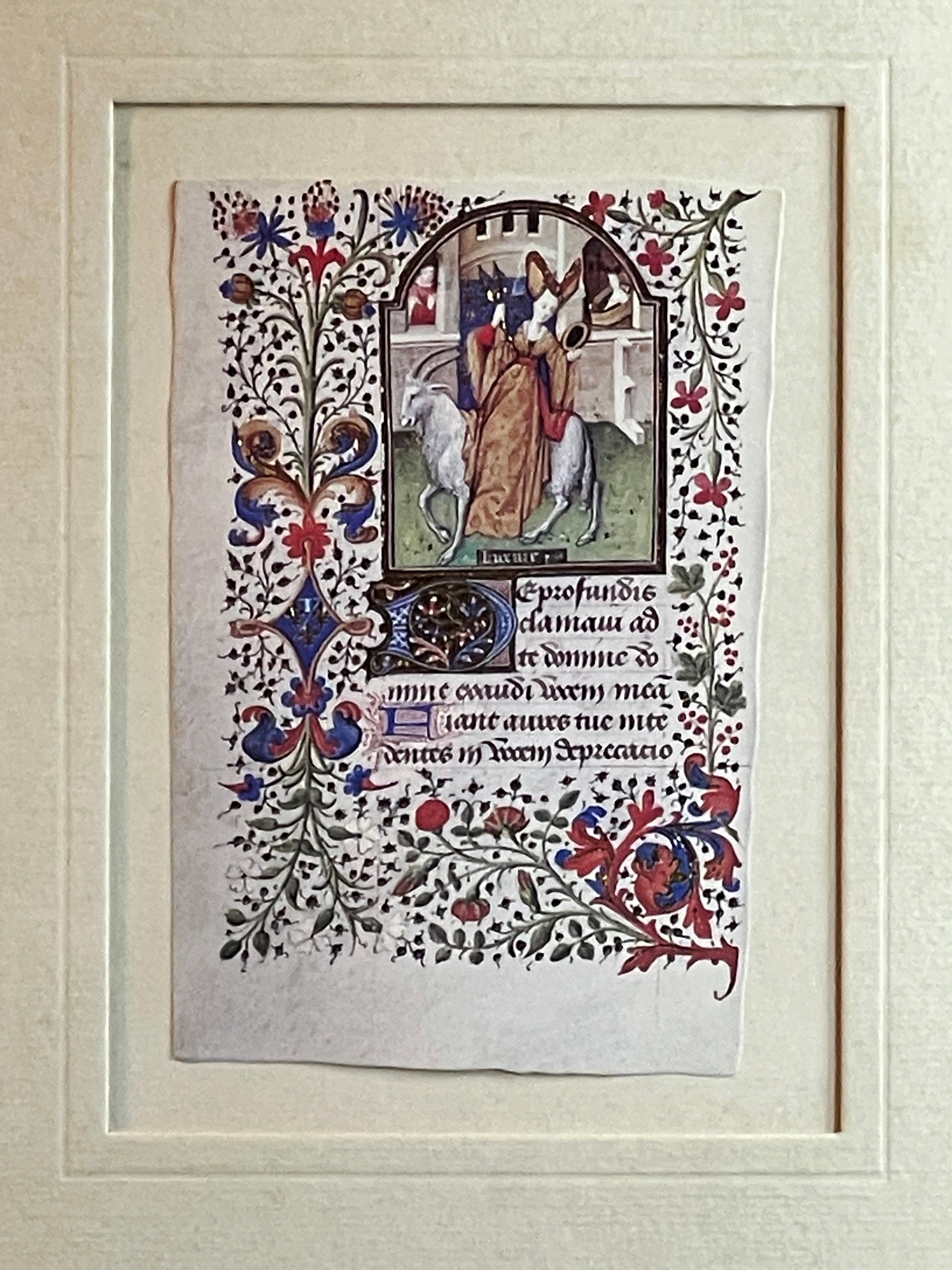 Illuminated manuscript leaf with a biblical procession scene and flowering acanthus border