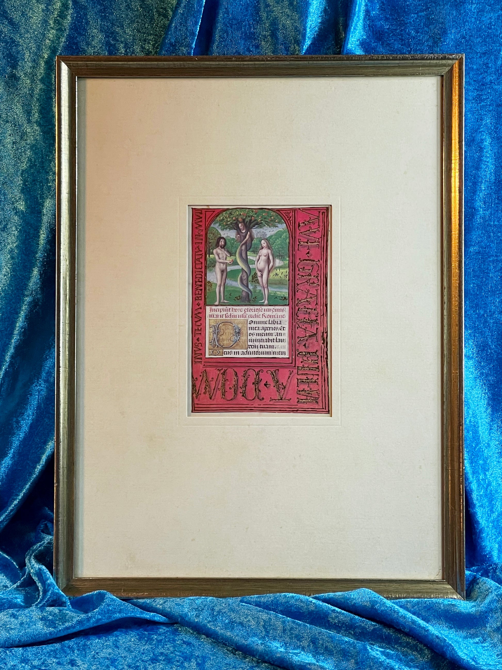 Illuminated manuscript miniature of Adam and Eve beneath the apple tree with vivid red border and gold lettering