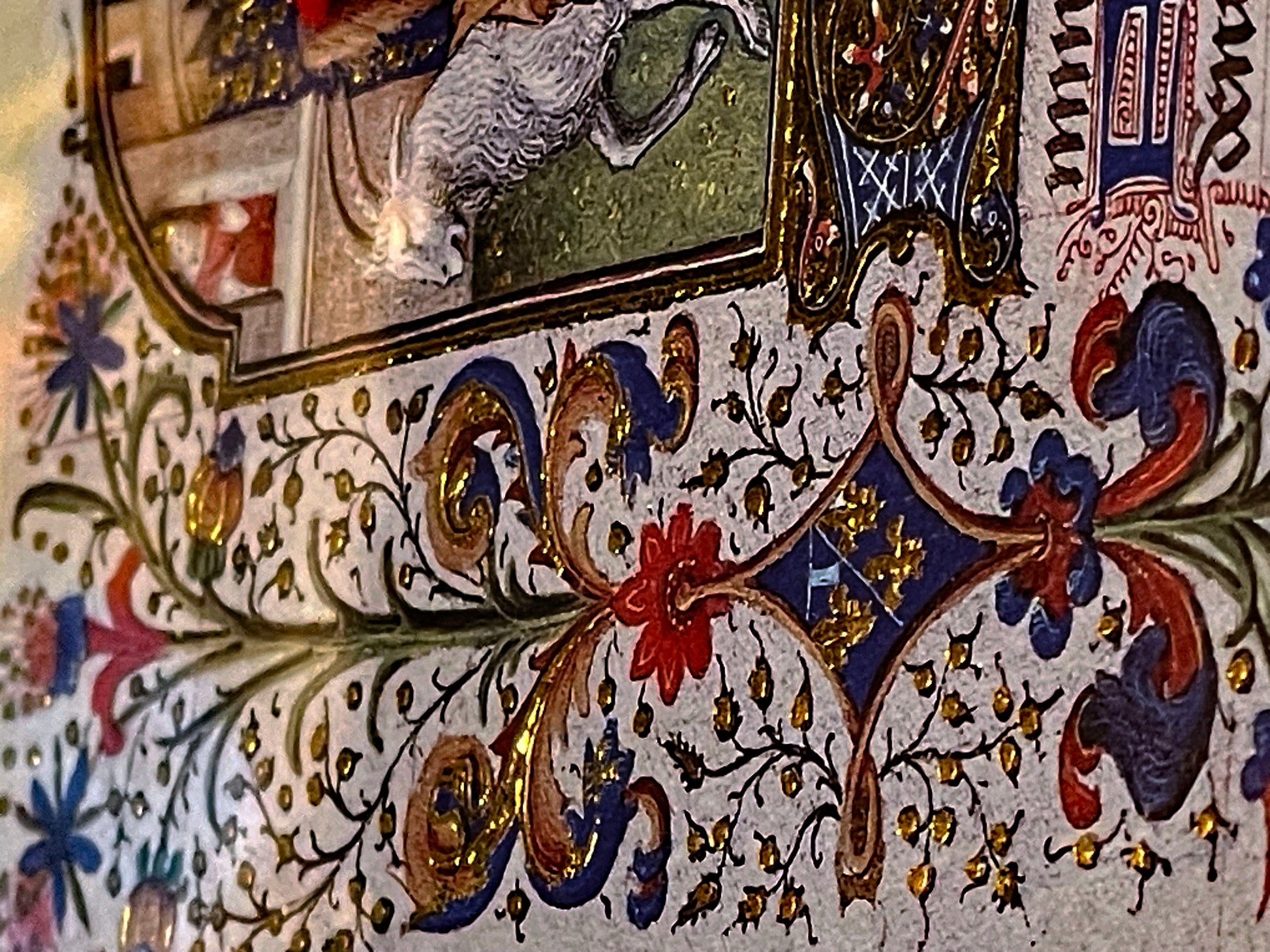 Detail of illuminated border with gold tooled acanthus, flowers and jewel tones