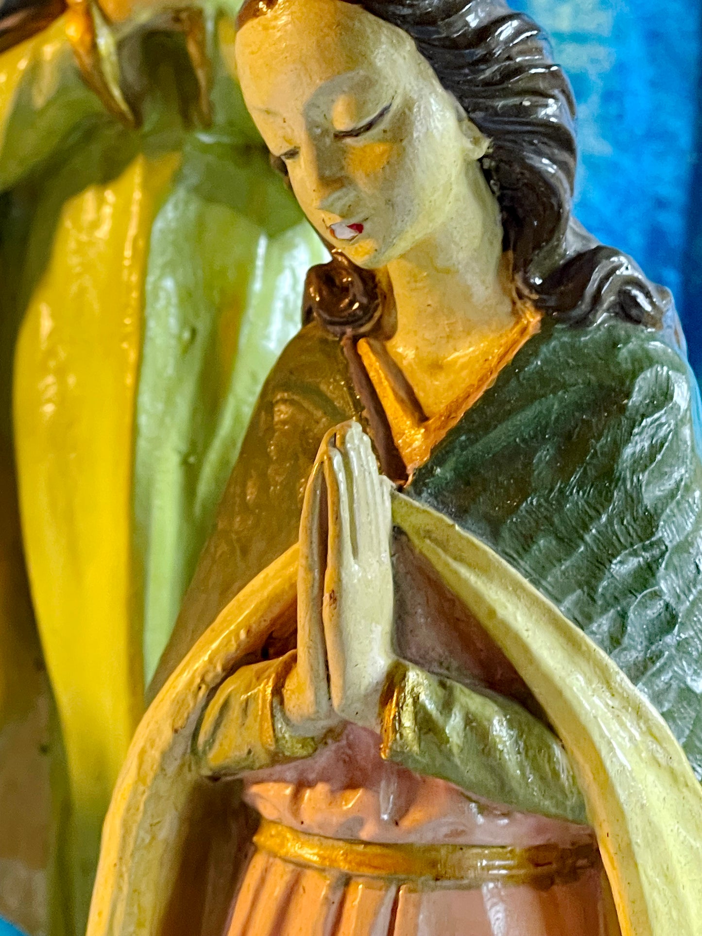 Kneeling young female saint figure with praying hands, painted detail