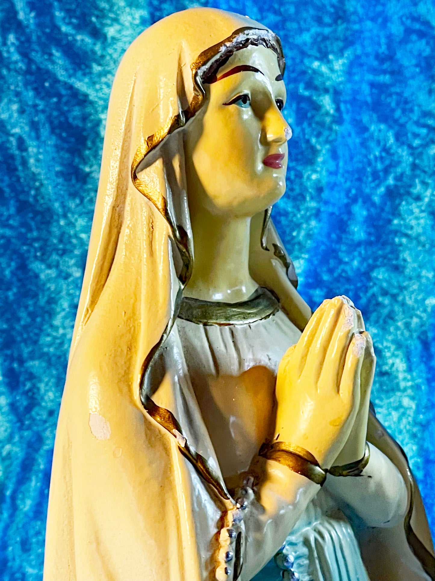 Close detail of the Madonna and Child faces and polychrome painting