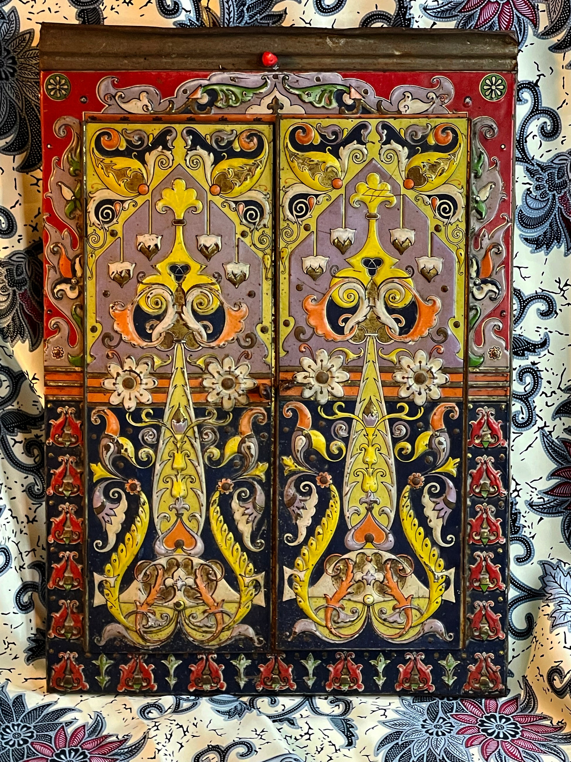 Painted polychrome wing doors of the folding mirror closed, with copper and arabesque motifs