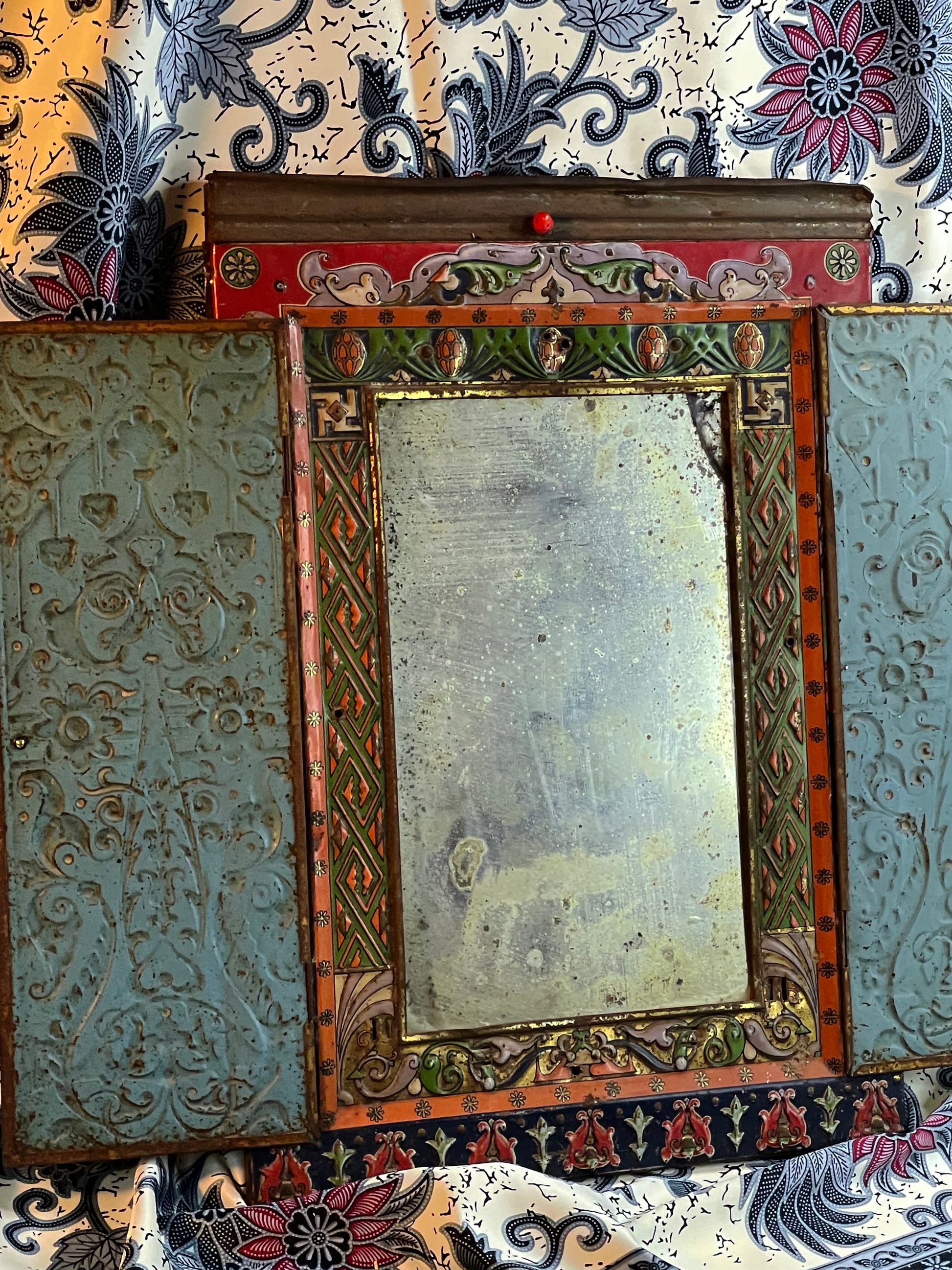 Mirror open at an angle showing the hammered copper repousse inner door panels