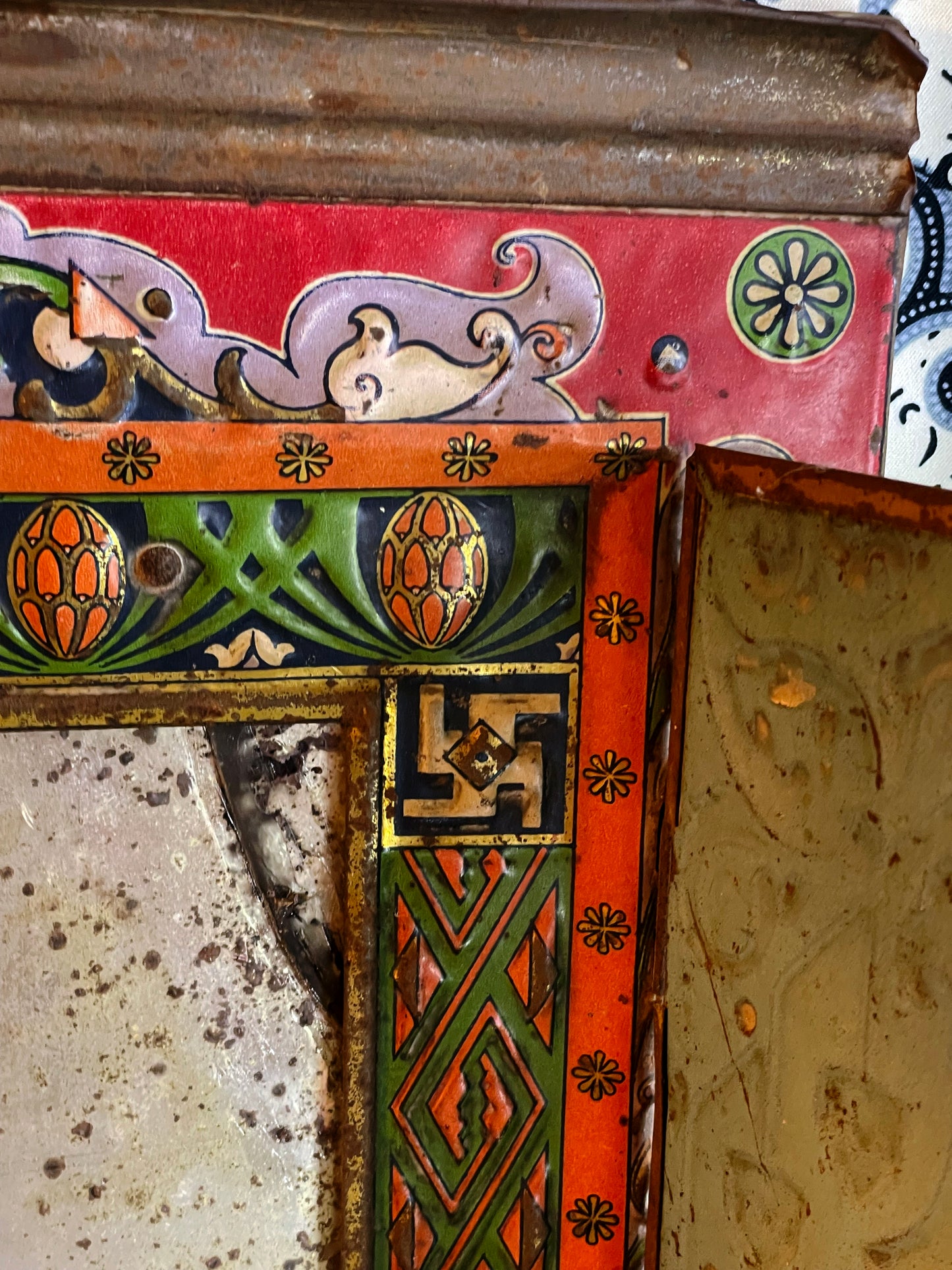 Detail of the painted corner border, geometric motifs and aged mirror patina