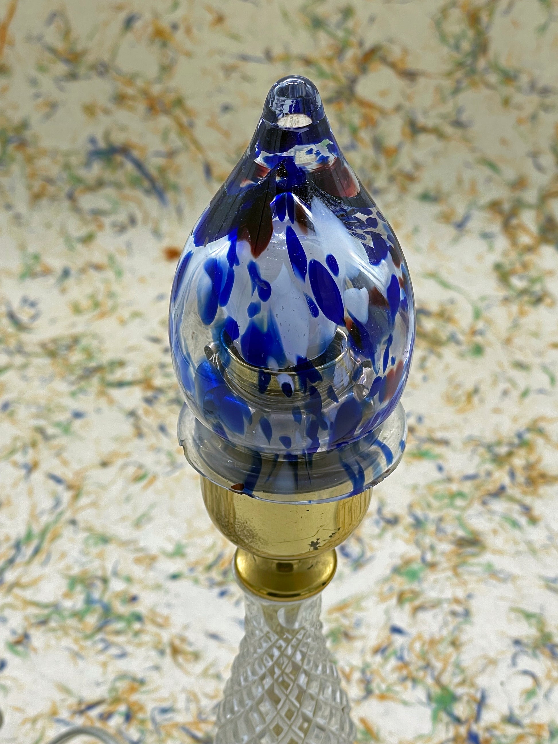 Close-up of hand-blown cobalt and amber Murano glass flame shade