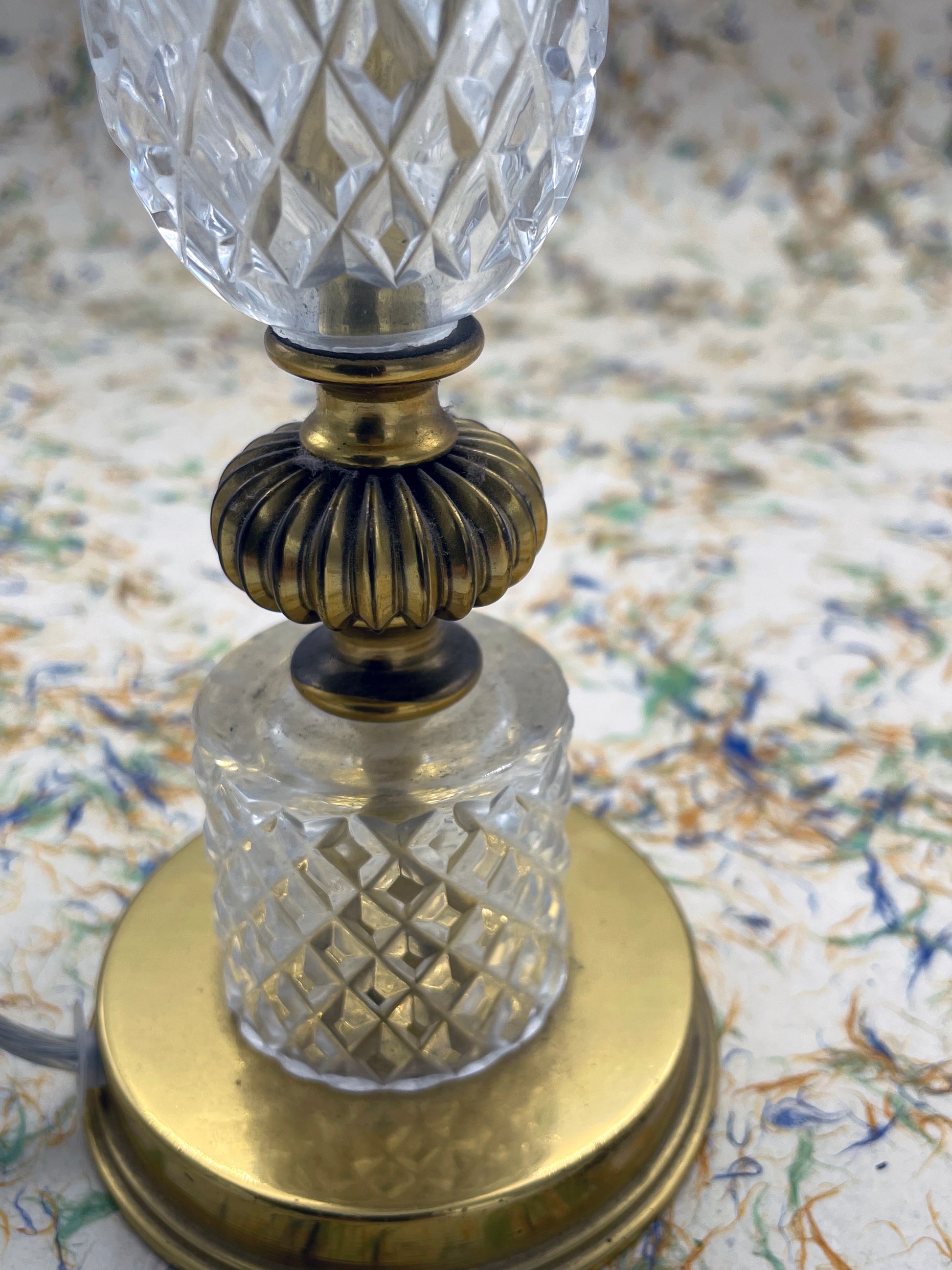 Detail of faceted cut-crystal column, ribbed brass collar and gilt-brass base