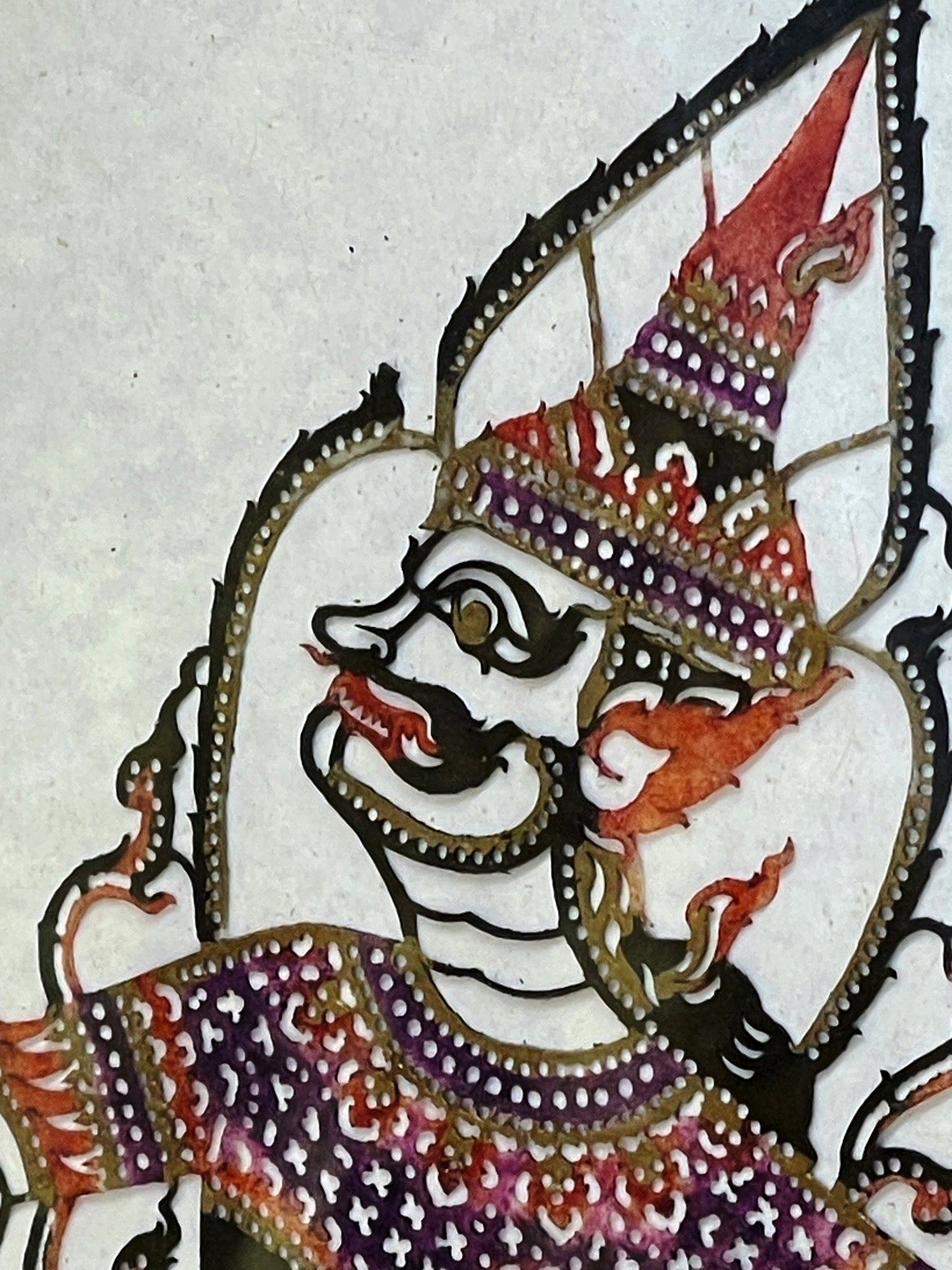 Detail of the deity's hand-painted face and pierced crown