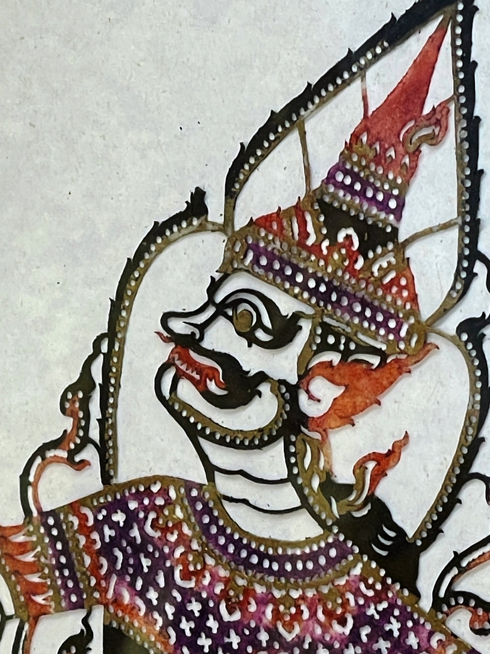Detail of the deity's hand-painted face and pierced crown