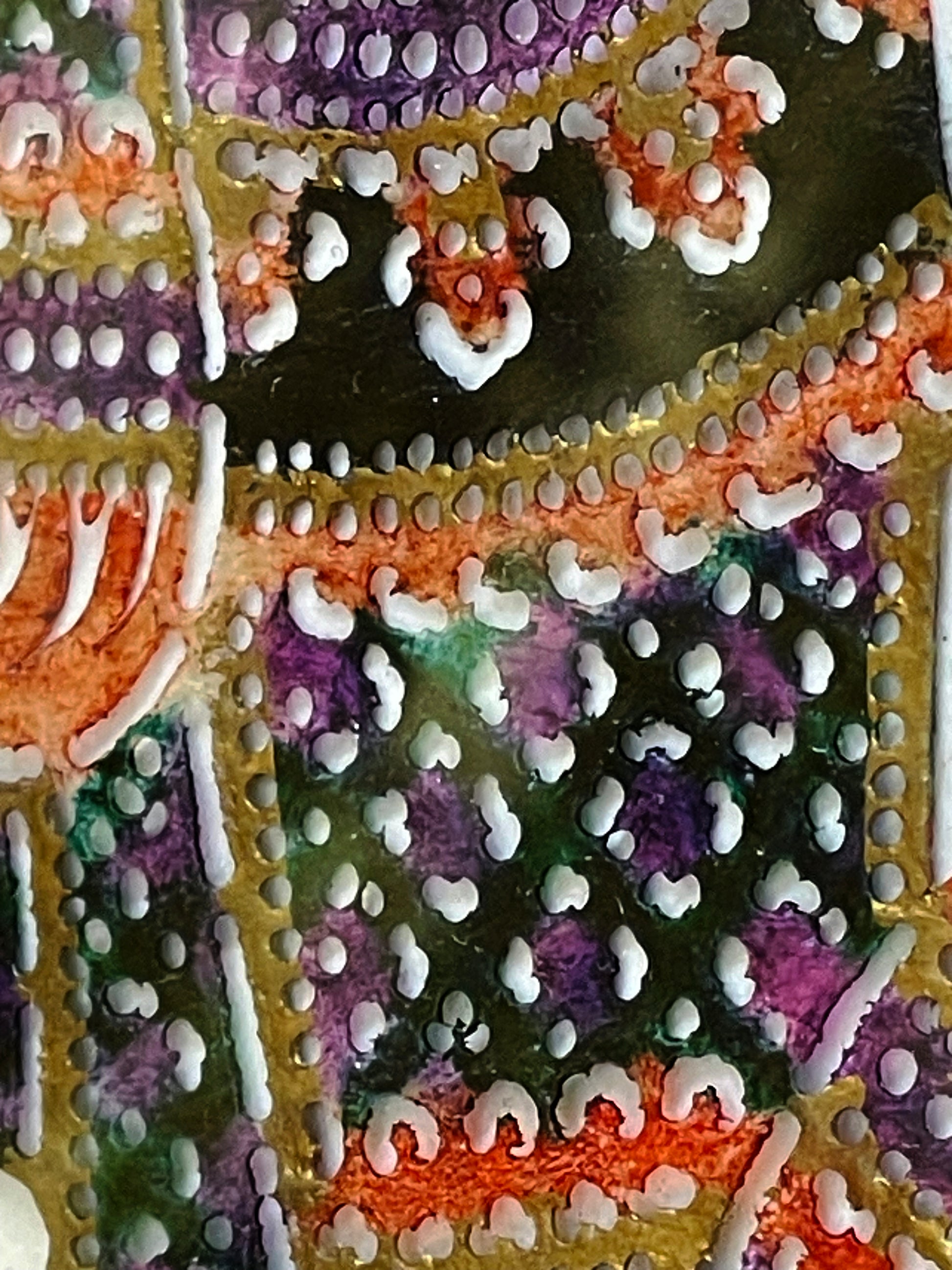 Beaded raised-paint texture across the filigree leatherwork