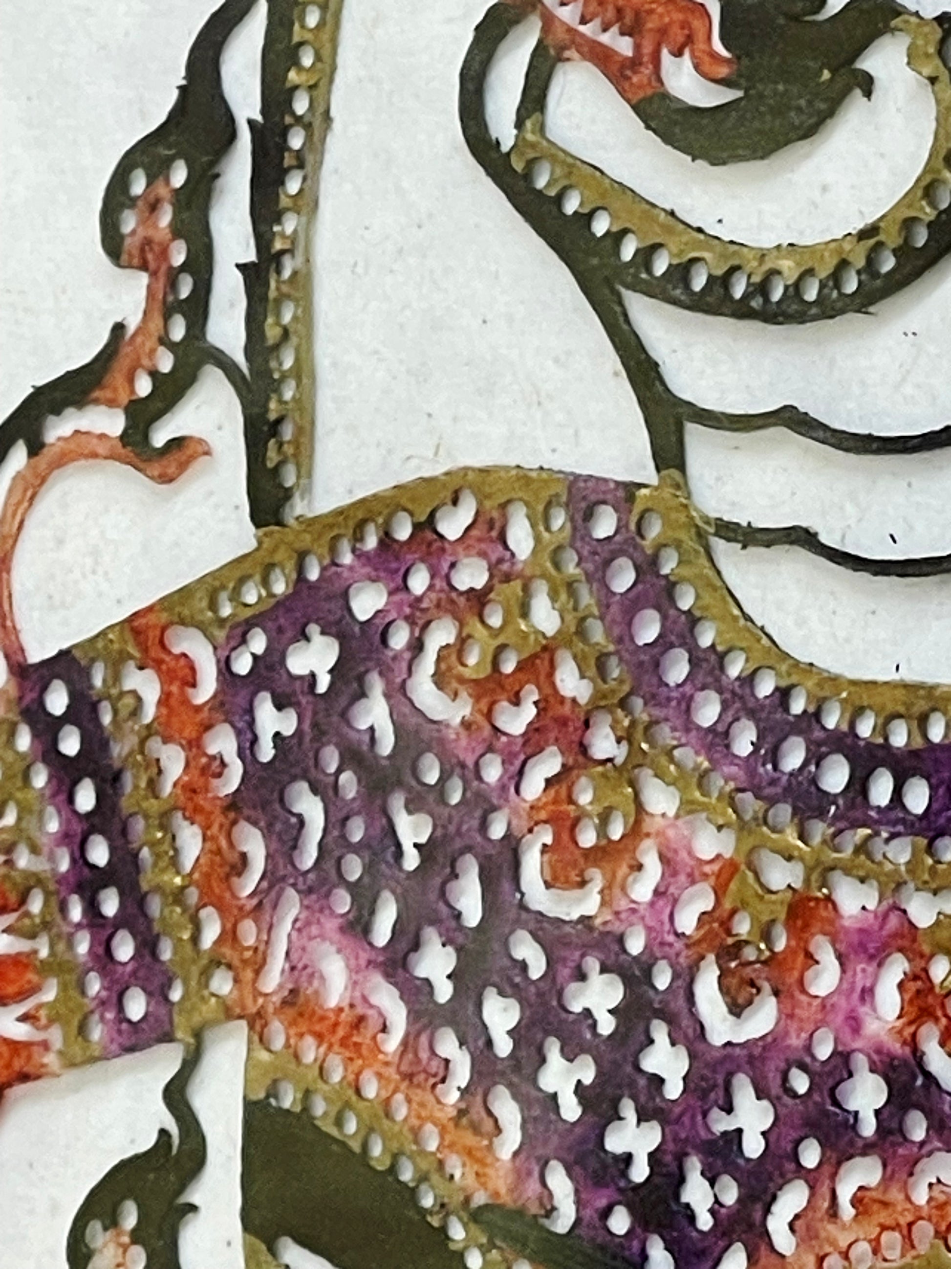 Pierced and painted leather garment detail in aubergine and terracotta