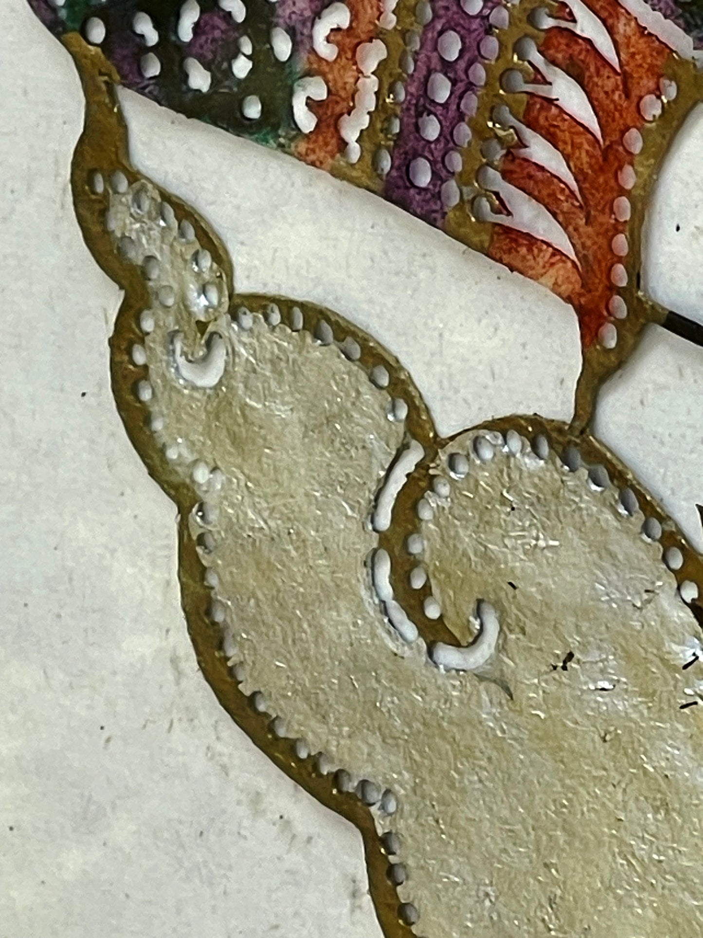 Gold and silver leaf cloud detail of the pierced leather panel