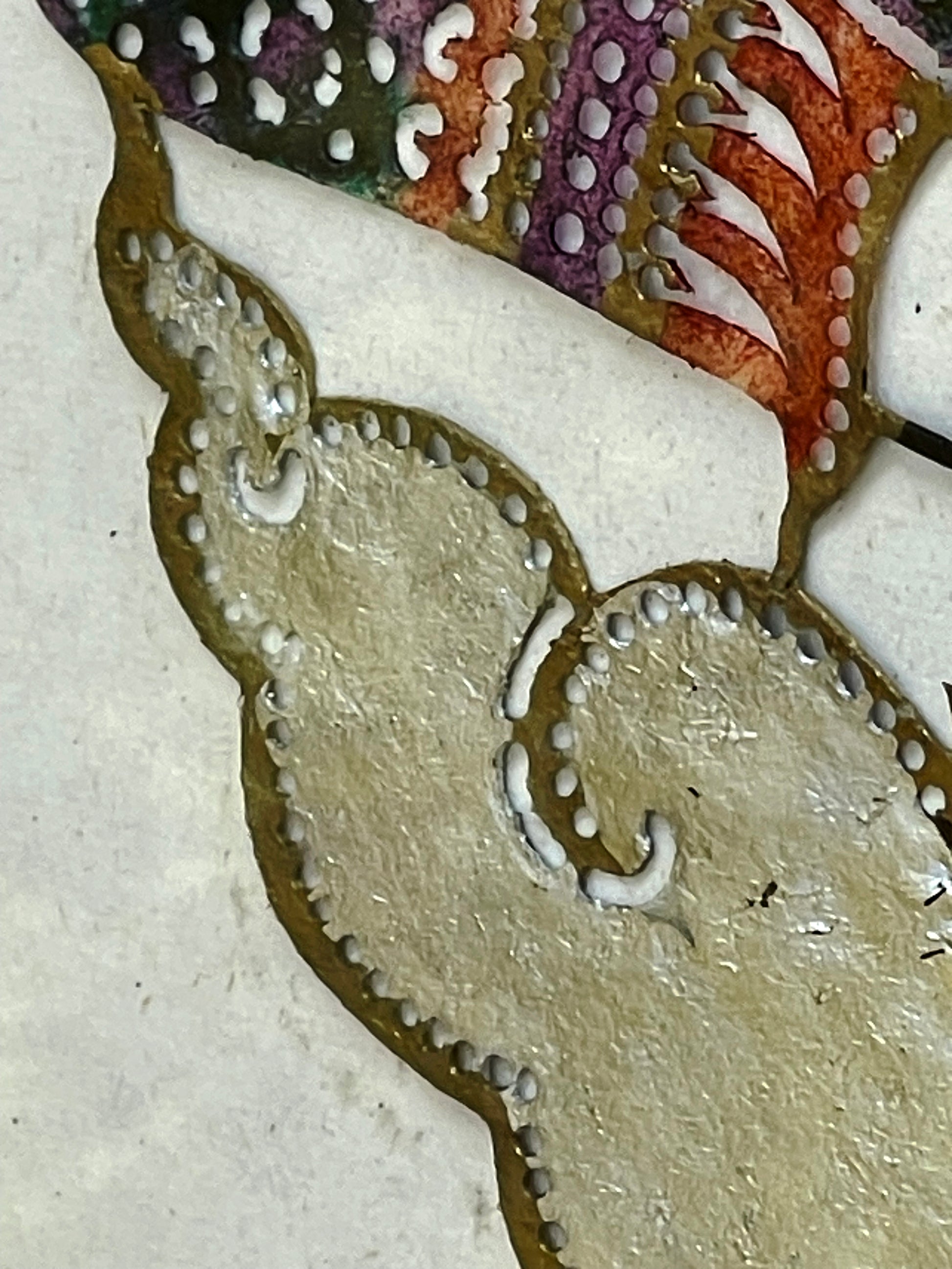 Gold and silver leaf cloud detail of the pierced leather panel