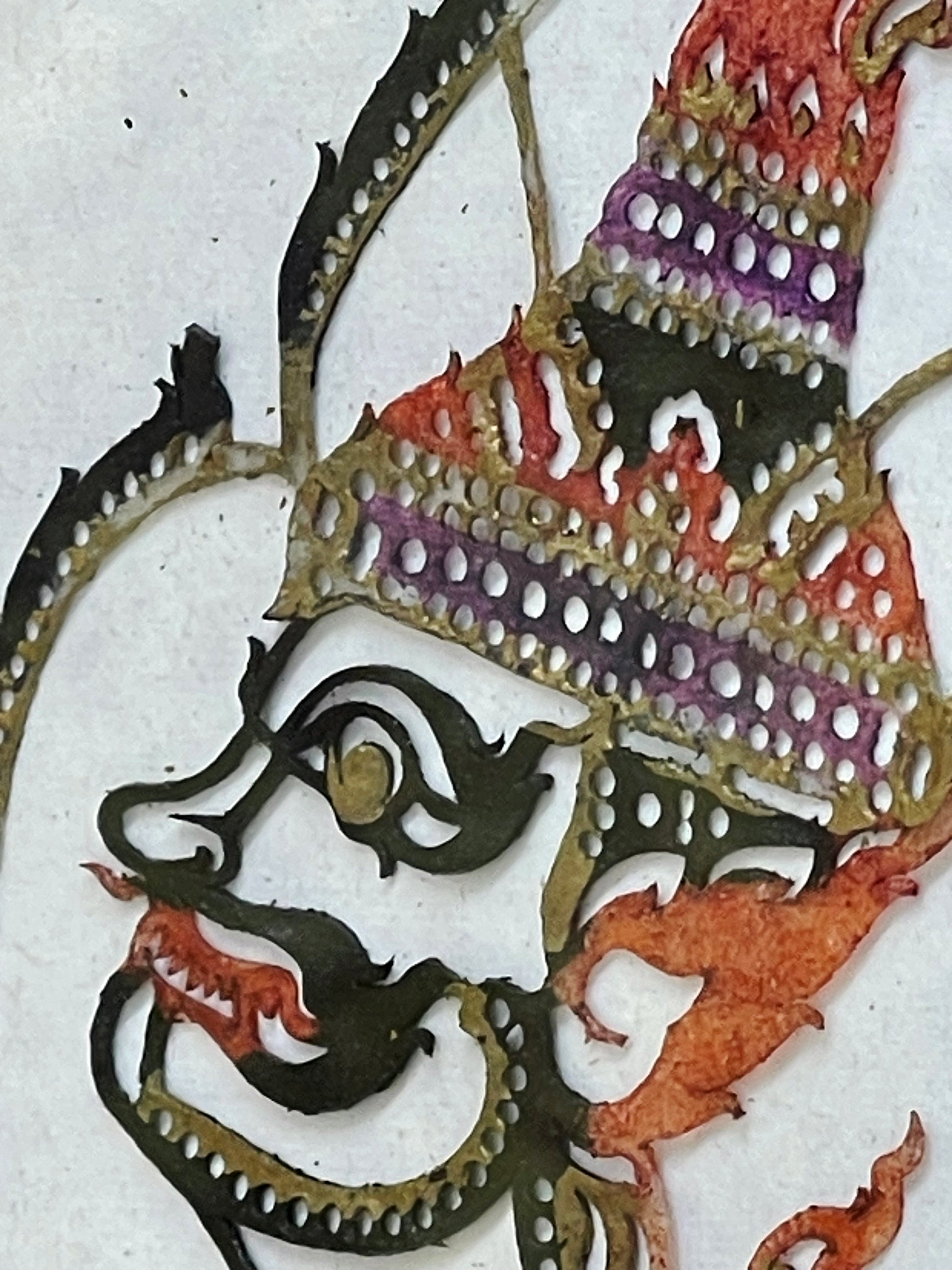 Close-up of the crowned head showing fine leather openwork and natural pigments