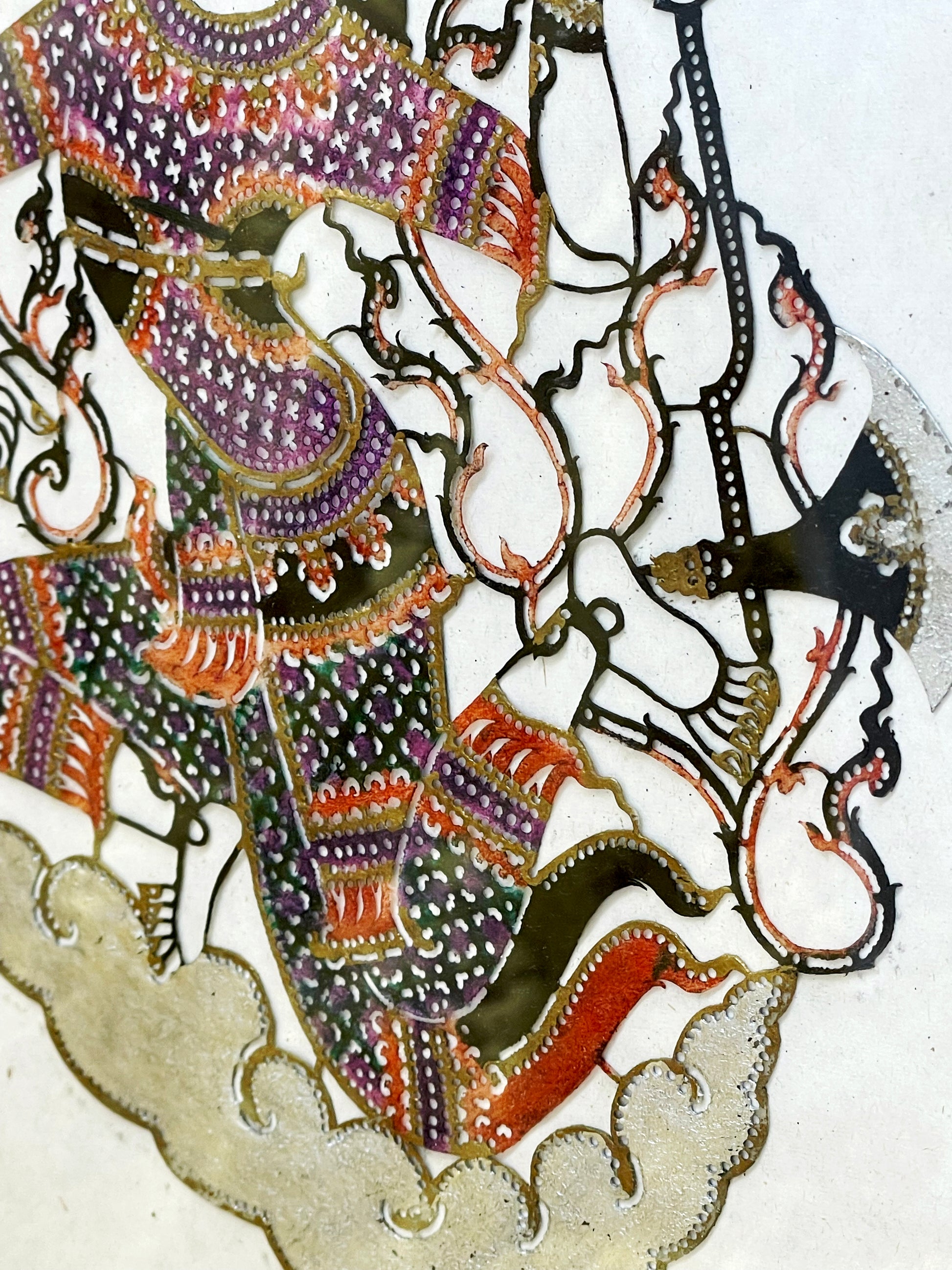 Lower body of the figure rising from burnished silver clouds
