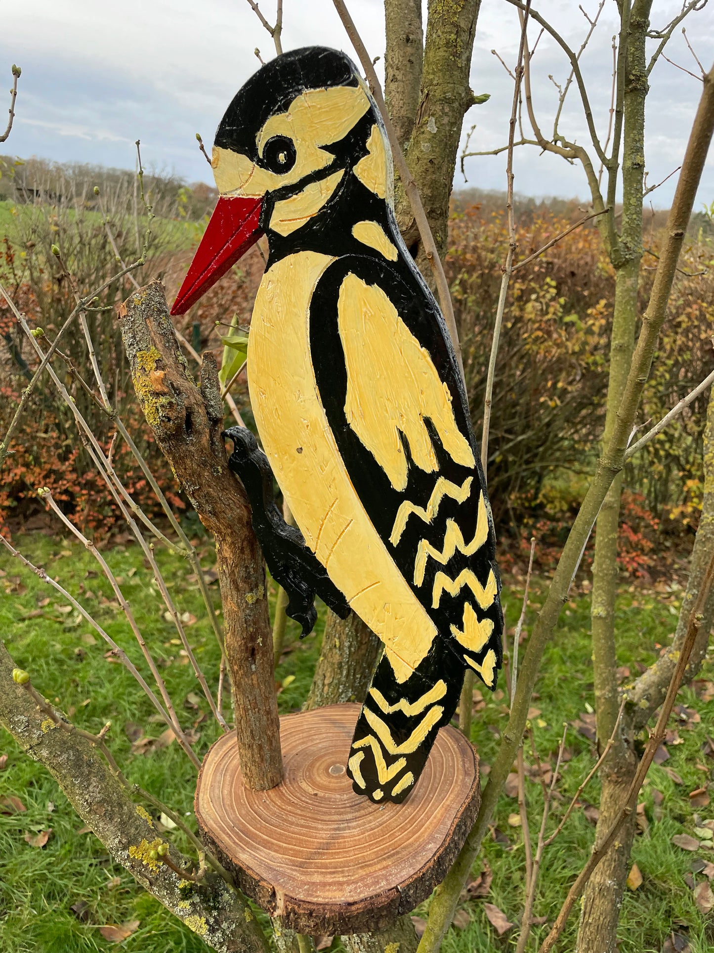 Three-quarter view of the standing wooden woodpecker decorative sculpture