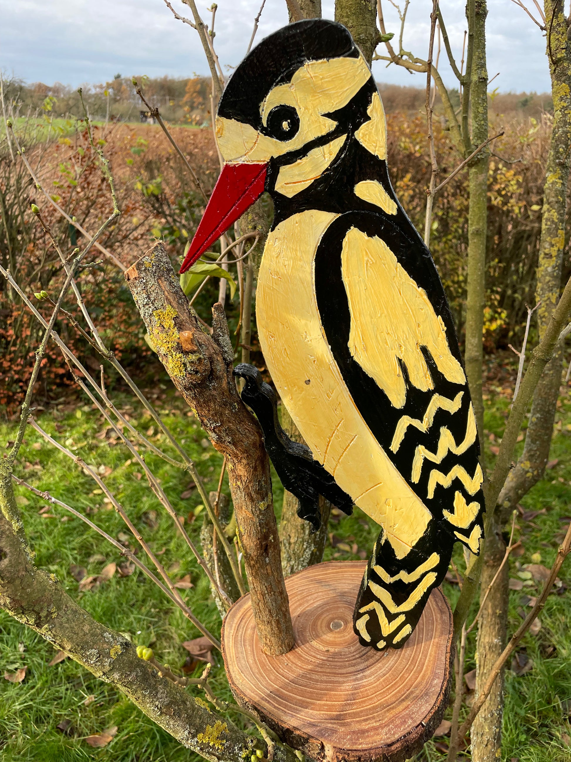 Folk-art carved woodpecker decorative object mounted on sawn log, alternate profile